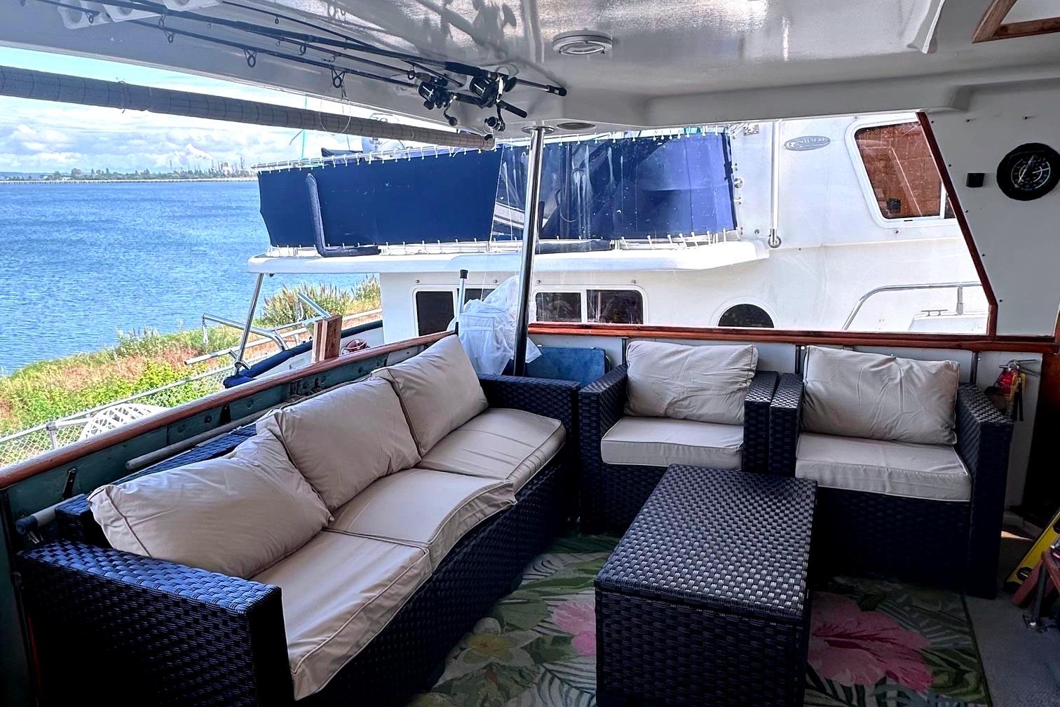 1991 Californian 52 Cockpit Motor Yacht with outdoor seating, overlooking serene waterfront.