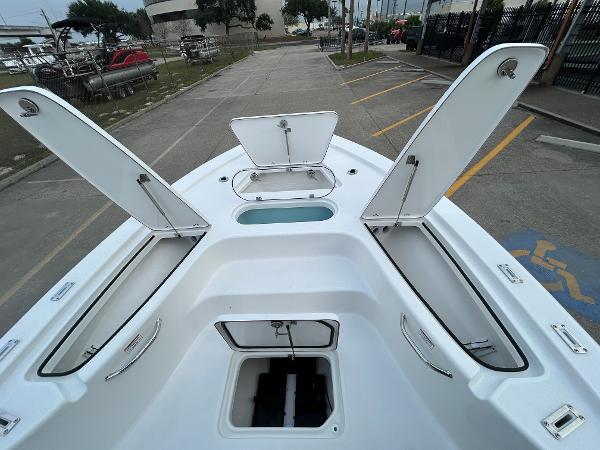 2024 Sea Pro 250 DLX boat with open storage compartments and sleek design.