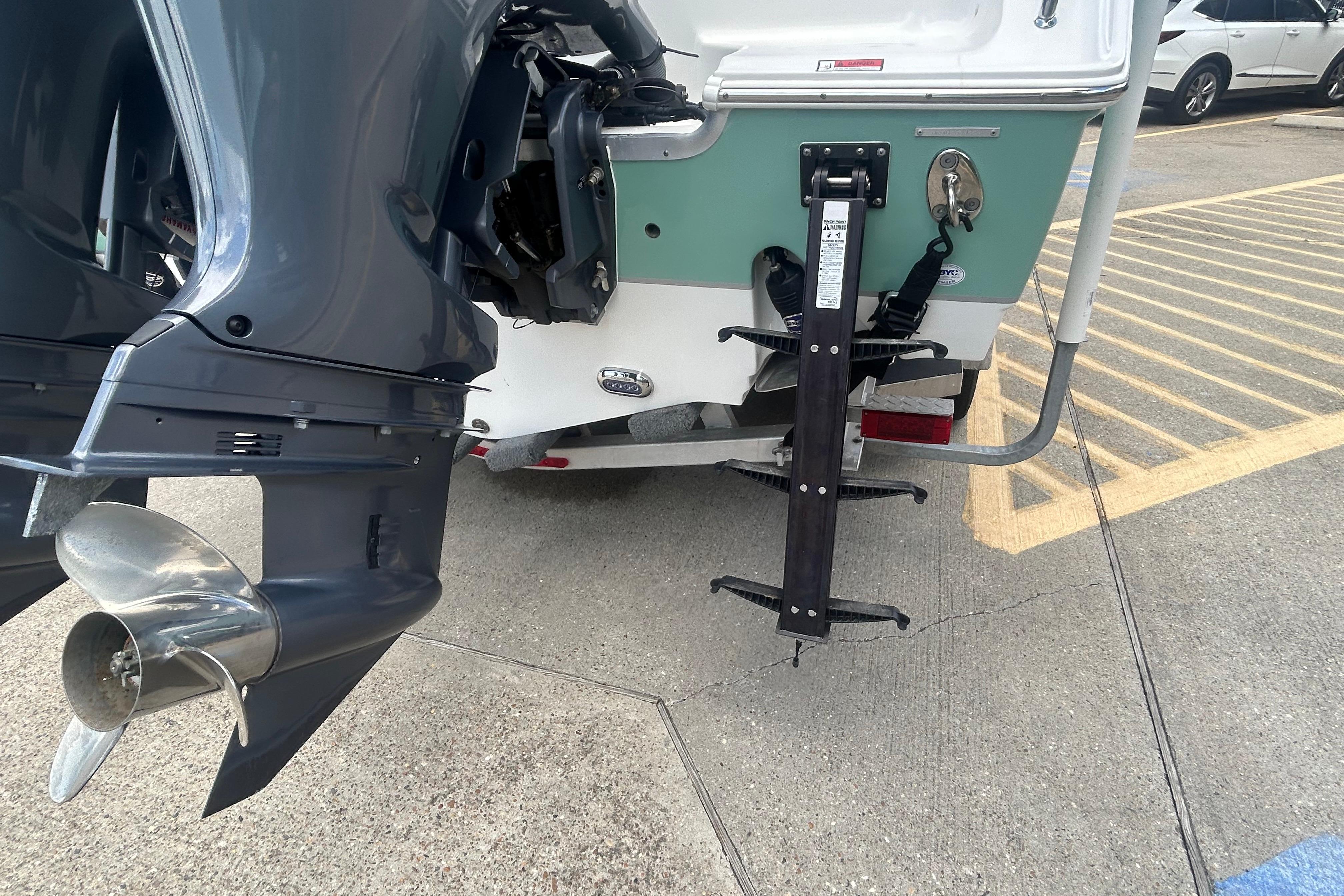 2023 Sea Hunt Gamefish 27 Coffin Box boat with outboard motor and boarding ladder.