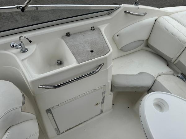 2006 Larson LXi 248 boat interior with sink and seating area.