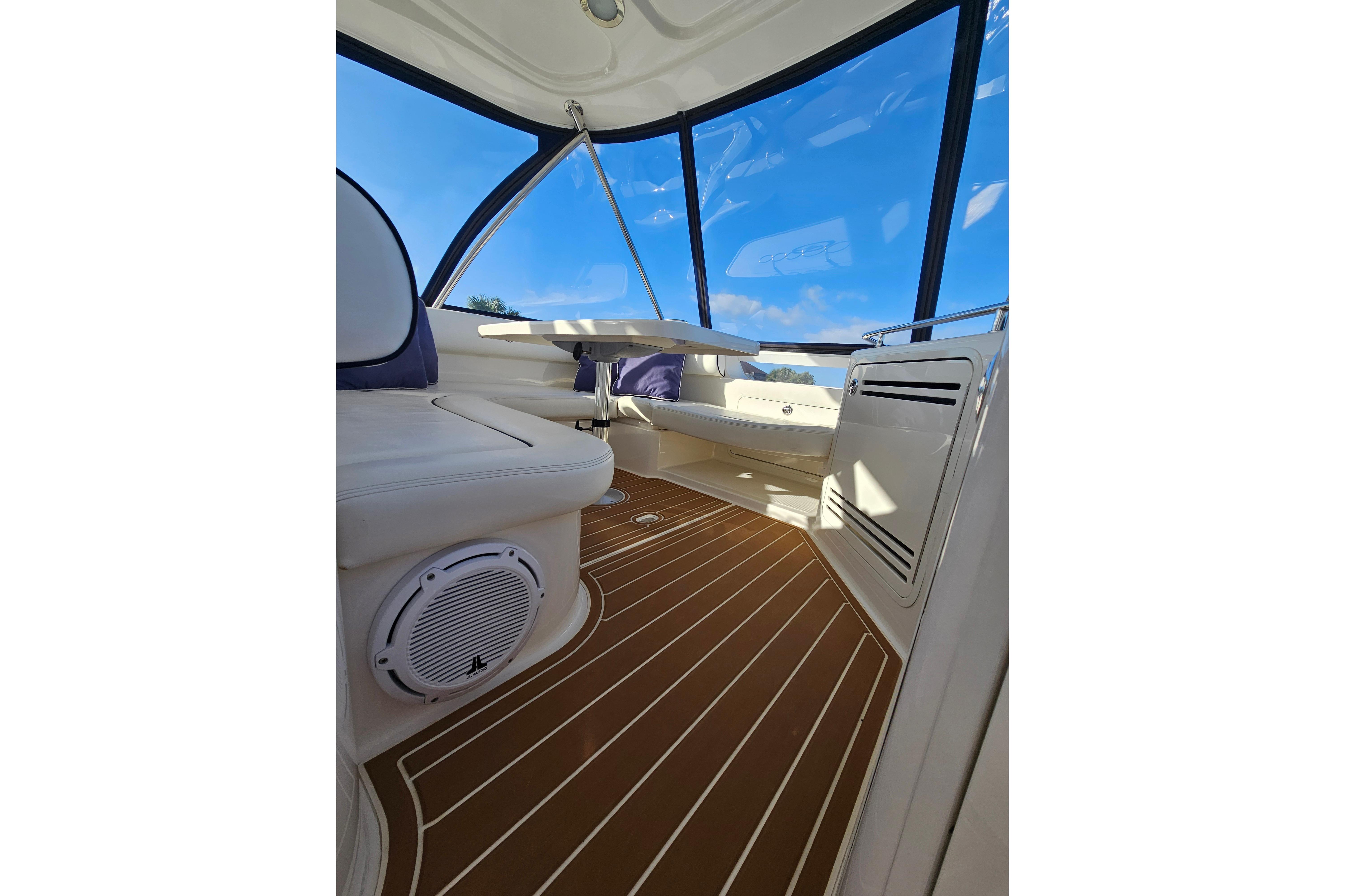 Interior view of 2006 Sea Ray 580 Sedan Bridge with sleek seating and wooden flooring.