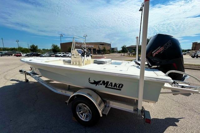 2026 Mako 18 Pro Skiff boat on trailer, parked outdoors under a clear sky.