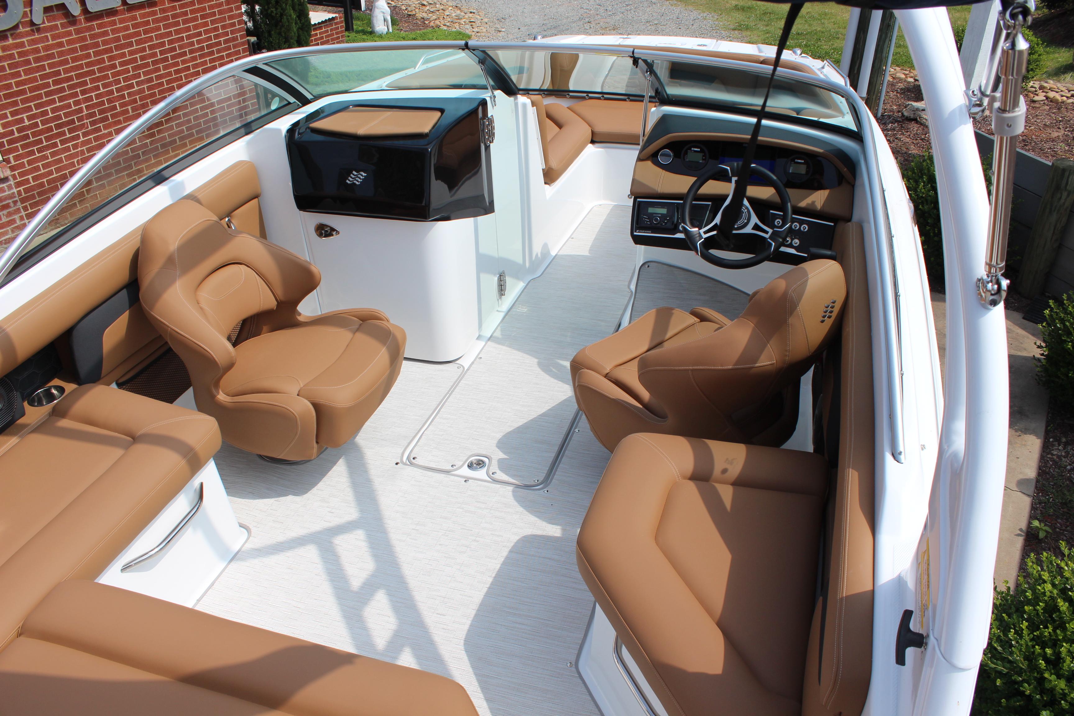 2025 Four Winns HD3 OB boat interior with tan seating and modern dashboard.