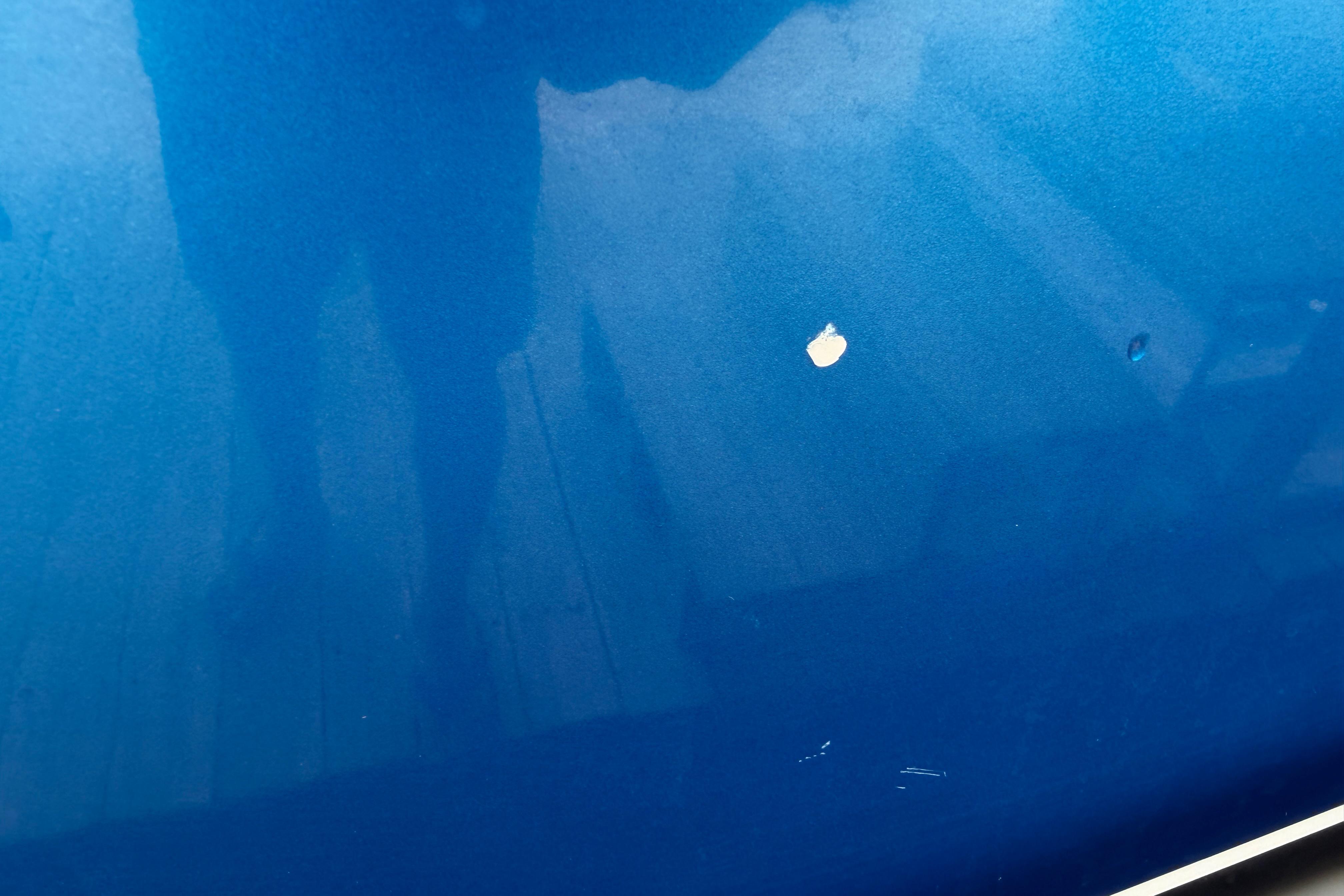 Blue Nor-Tech 477 SPX Vee Bottom 2013 with visible paint chip.