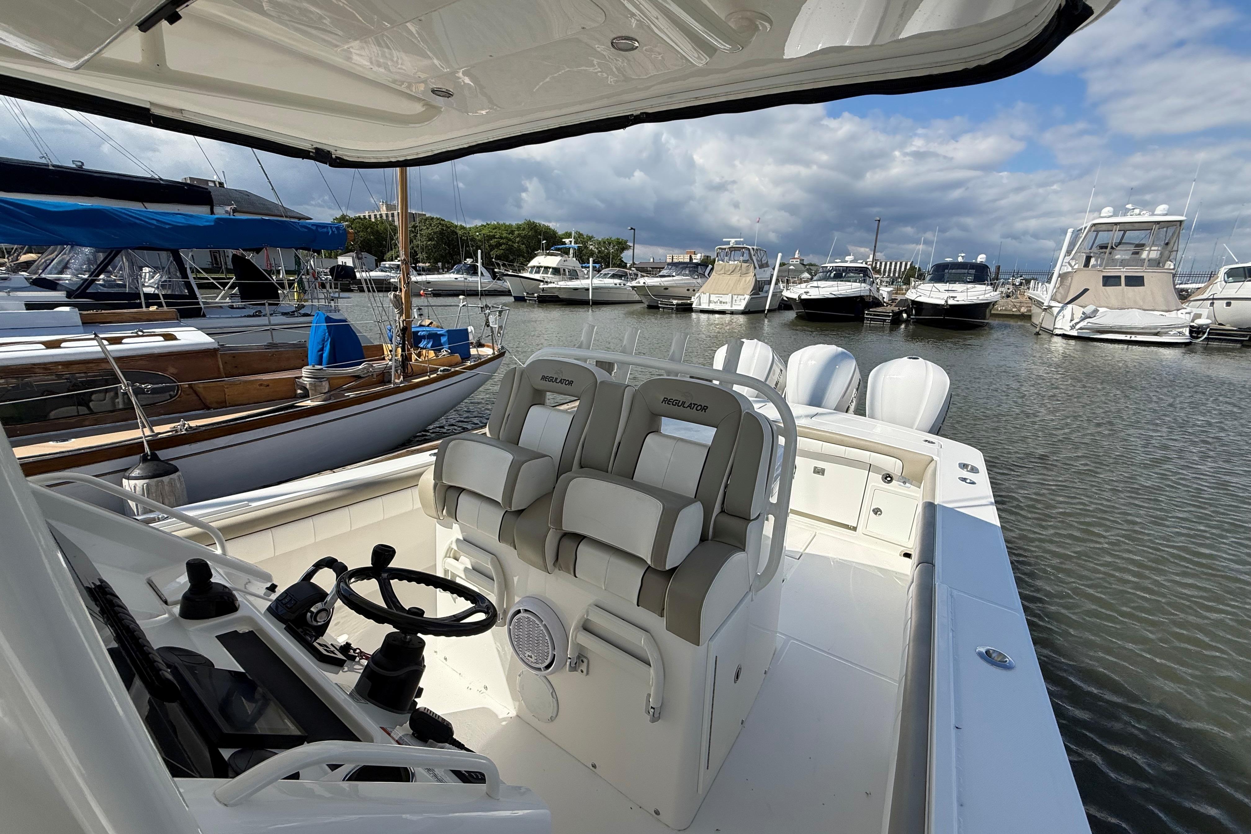 2019 Regulator 34SS boat interior with helm and seating, docked at a marina.