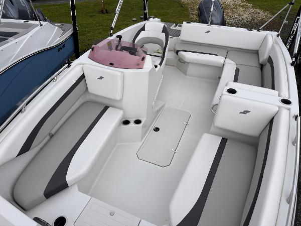 2024 Starcraft 171 SVX boat interior with white and gray seating, modern design, and spacious layout.