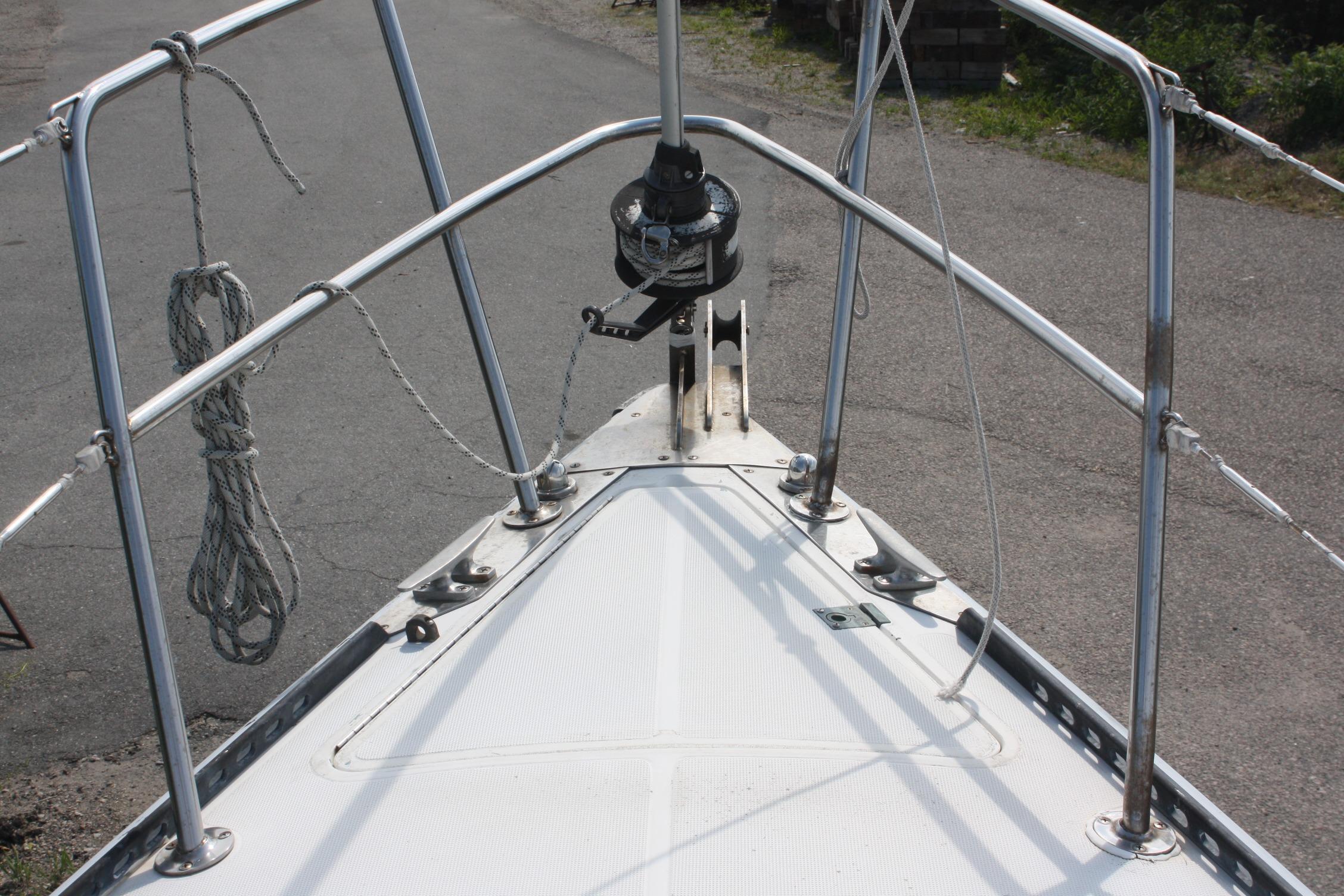 Bow of 1981 S2 9.2A sailboat with stainless steel railings and winch.