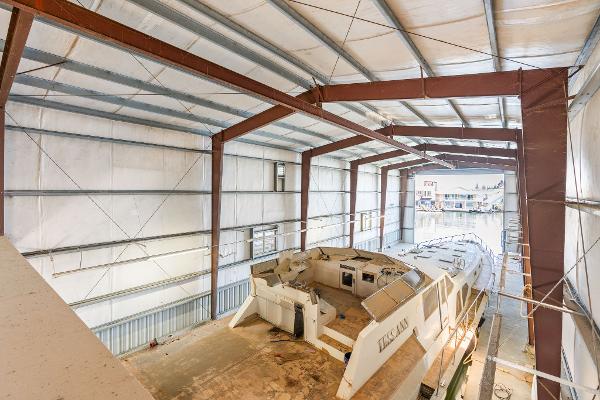 1985 Custom Larson Boathouse interior with large boat docked inside.