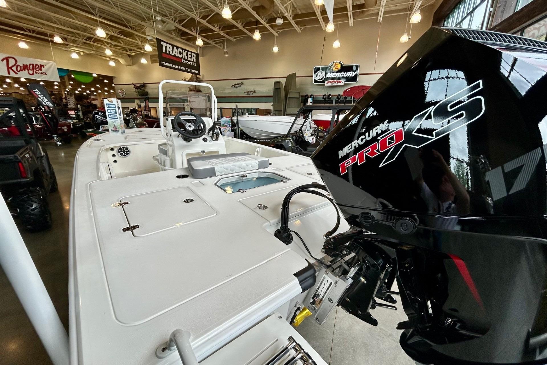 2026 Mako Pro Skiff 18 boat with Mercury Pro XS engine in showroom.