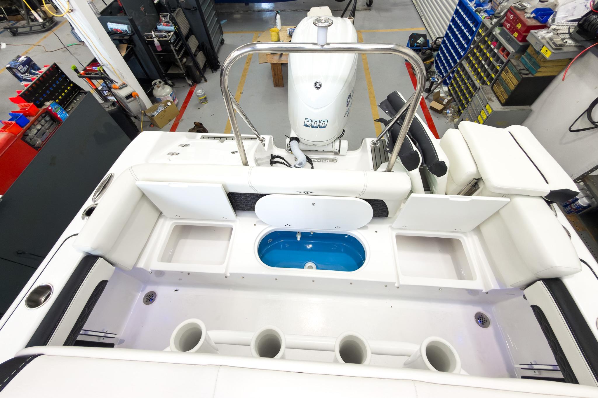 The image shows the cockpit of a Tidewater 220 LXF boat with a 200 HP outboard motor.