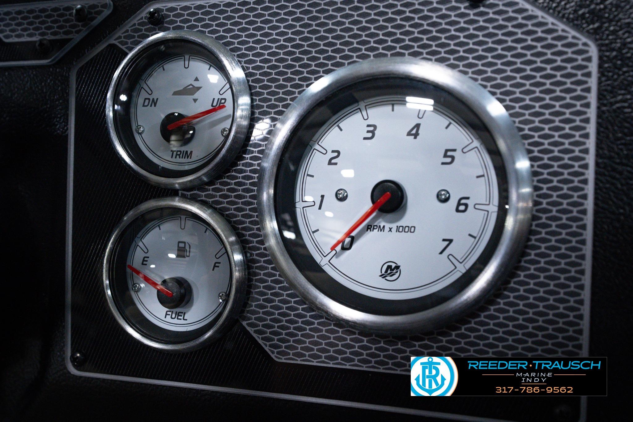 Dashboard gauges of 2026 Lund 1875 Impact XS SS boat, featuring RPM, trim, and fuel indicators.