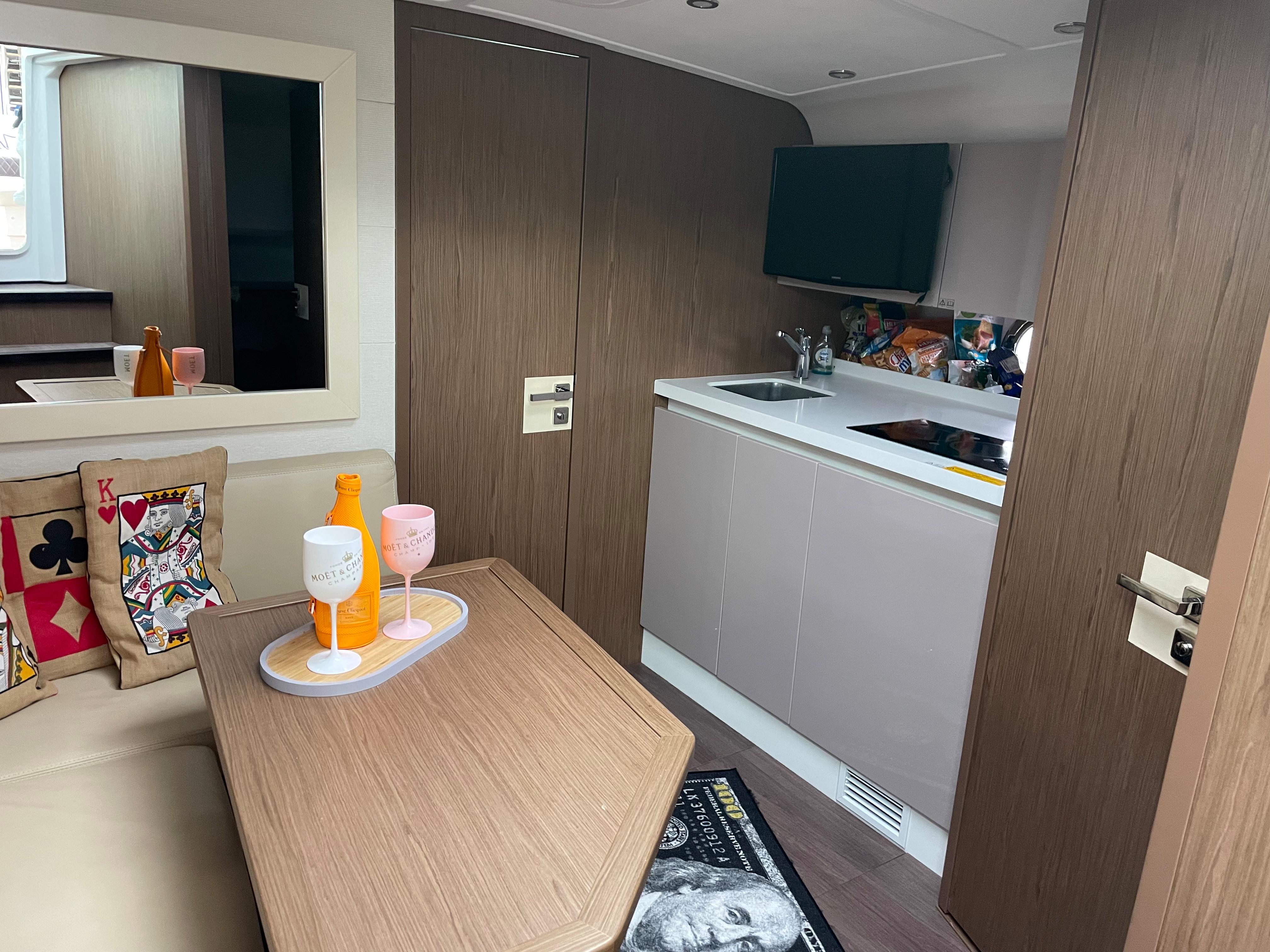 Interior of 2018 Beneteau Gran Turismo 40 yacht with modern kitchen and cozy seating area.