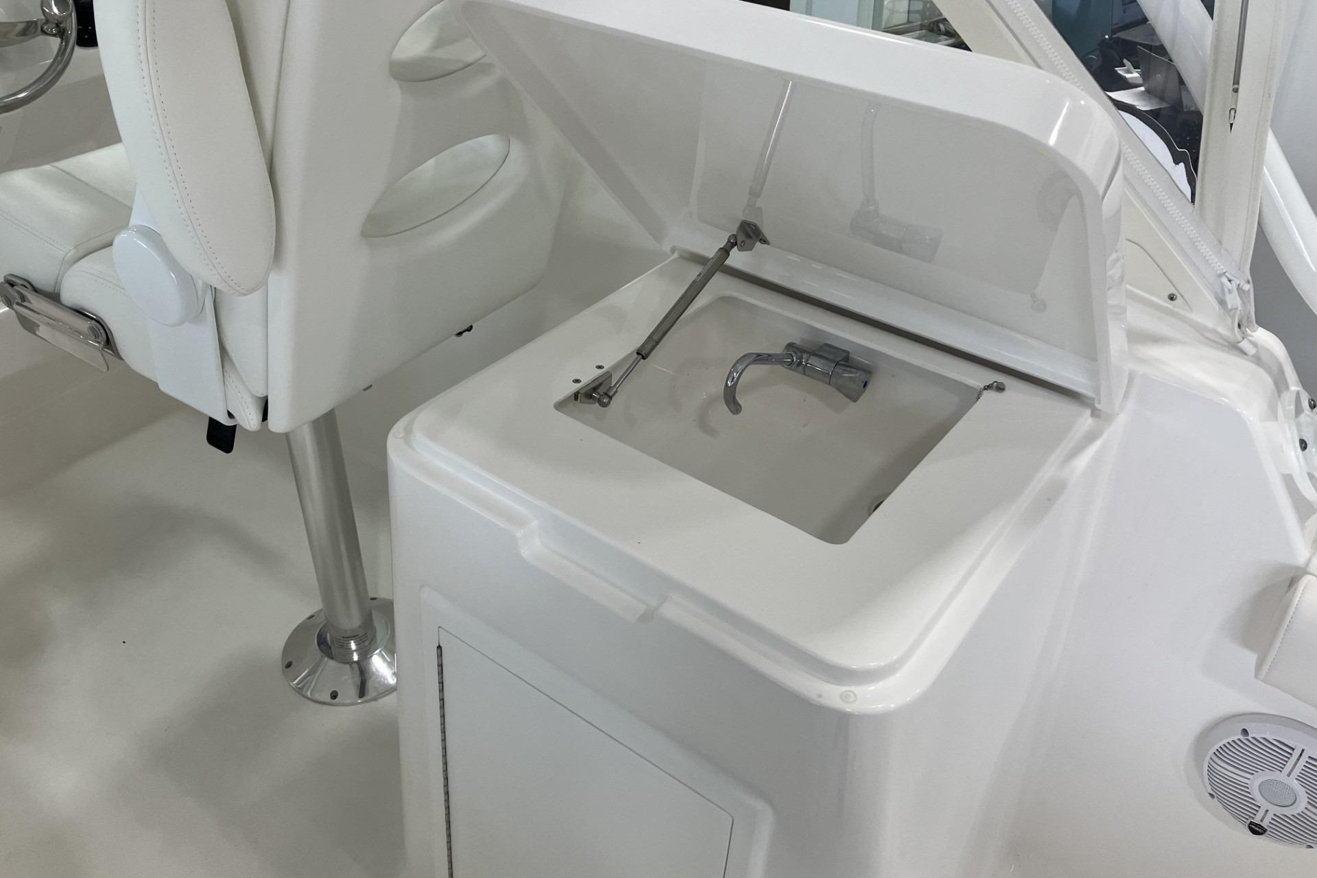 2026 Albemarle 27 Dual Console boat interior with open storage compartment and seating.