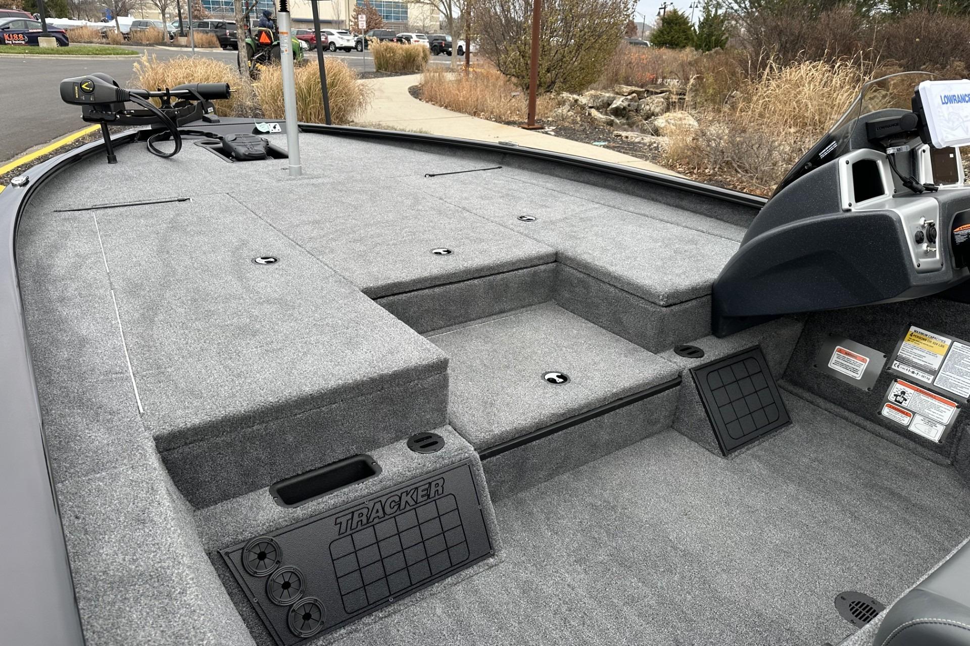 2025 Tracker Savage 215 boat interior with carpeted deck and control console.