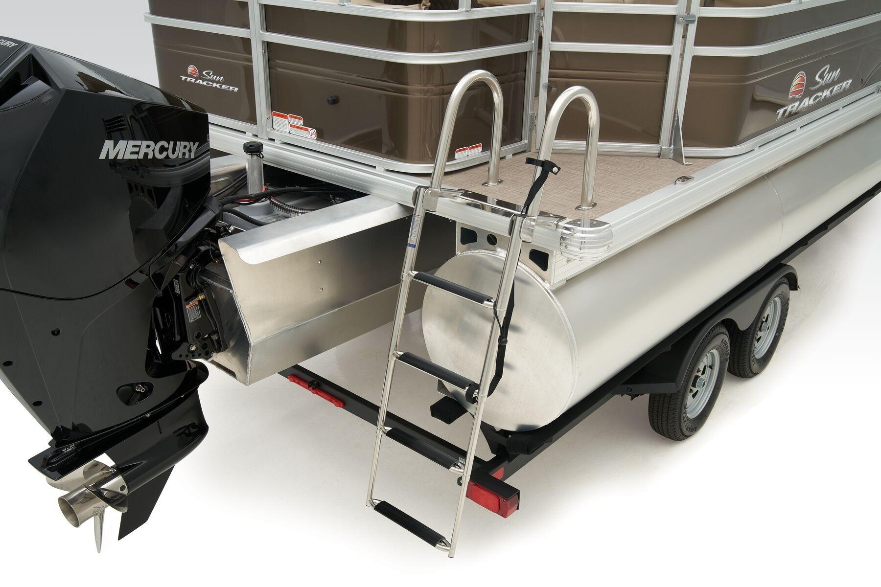 2023 Sun Tracker SportFish 22 XP3 pontoon boat with Mercury engine and ladder.