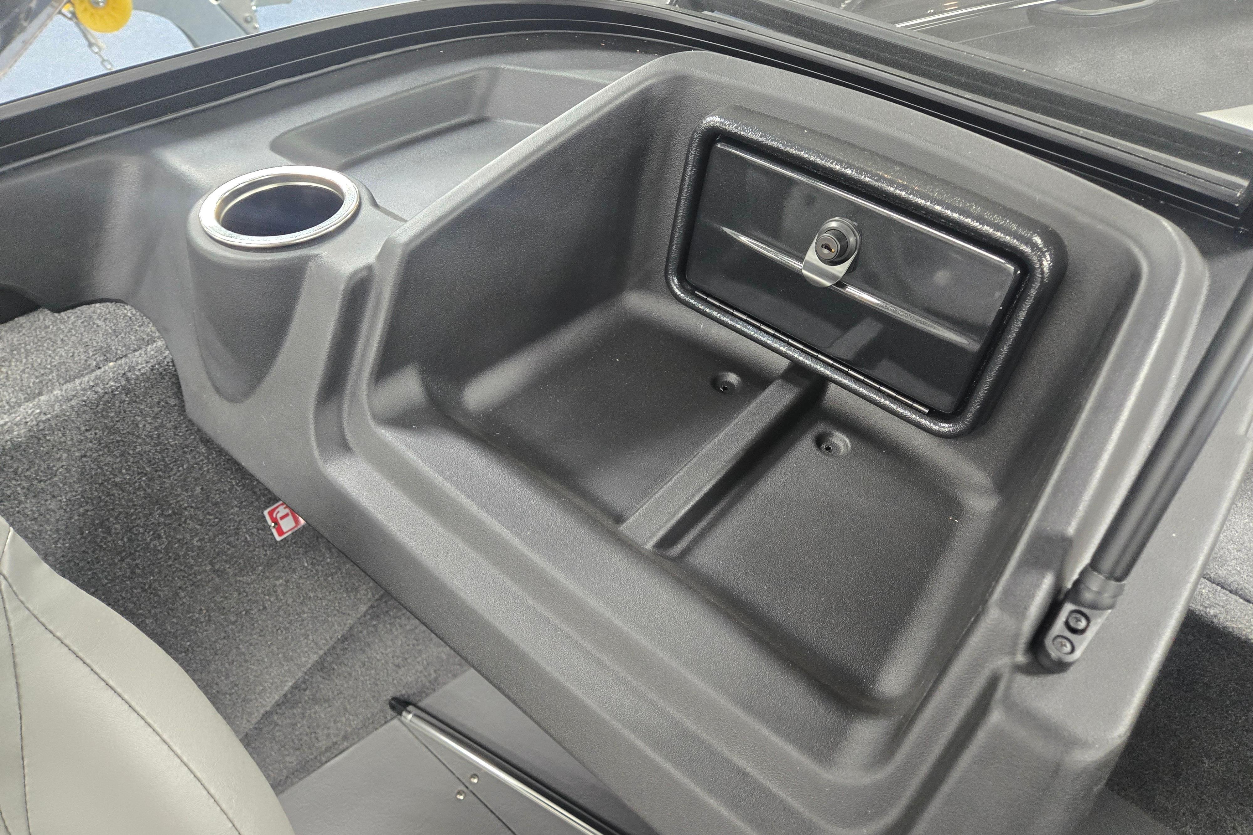 Interior of 2026 Princecraft Sport 175 MAX boat, featuring storage compartment and cup holder.