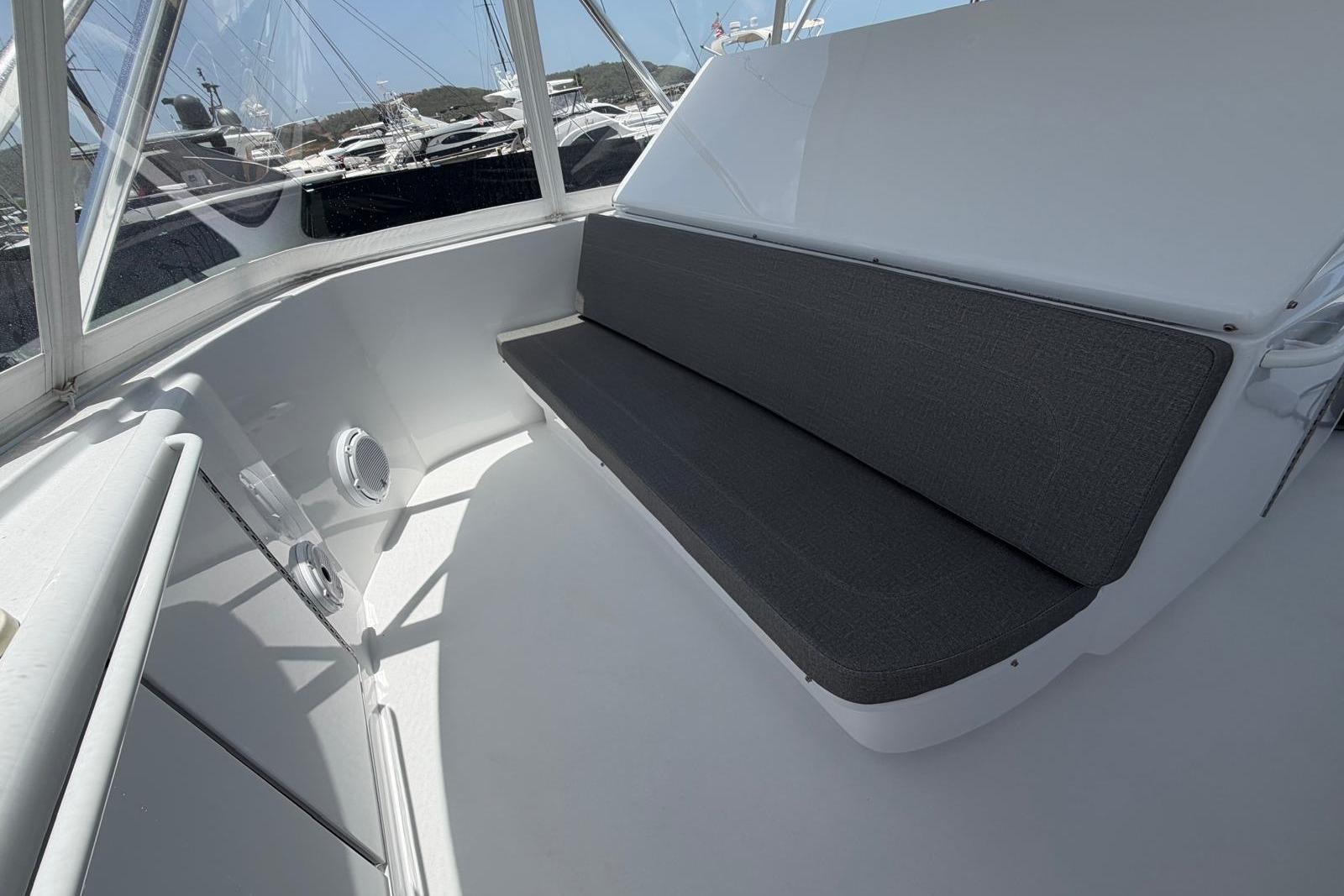 Interior seating area of a 2003 Hatteras 54 Convertible yacht with gray cushions.