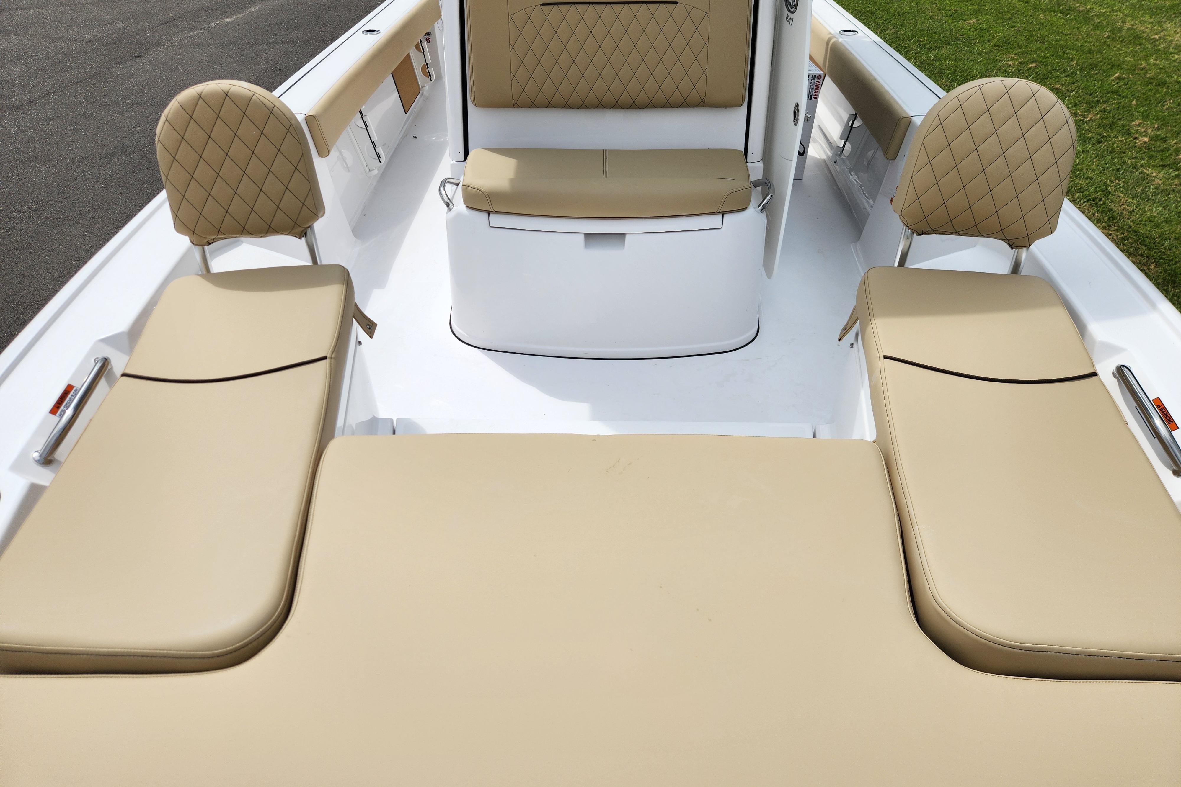 2026 Sportsman Masters 247 Bay Boat interior with tan cushioned seating and diamond stitching.