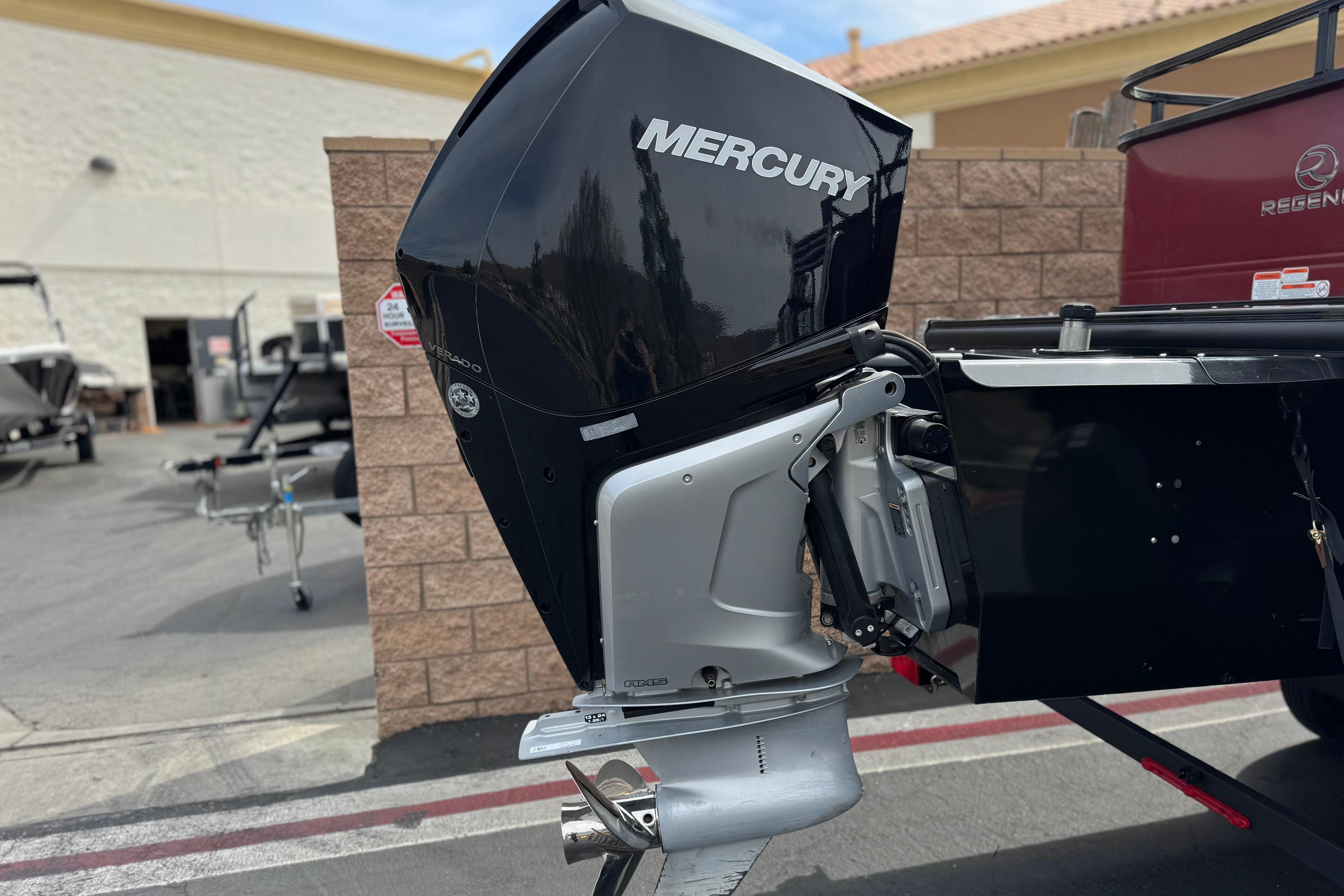 2022 Regency 250 DL3 boat with Mercury outboard motor in a dealership lot.