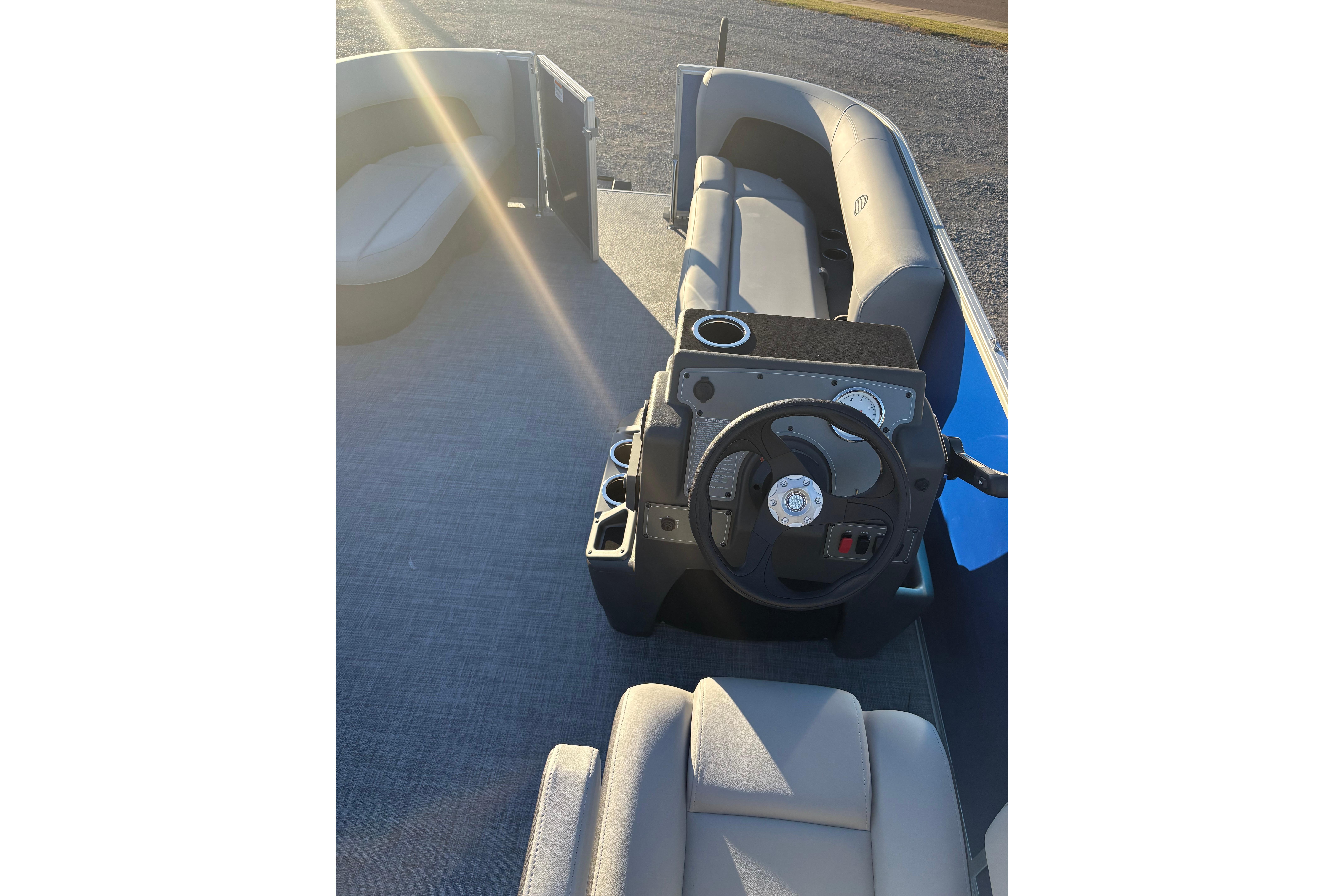 2026 Sun Tracker Party Barge 16 DLX interior with steering wheel and seating.