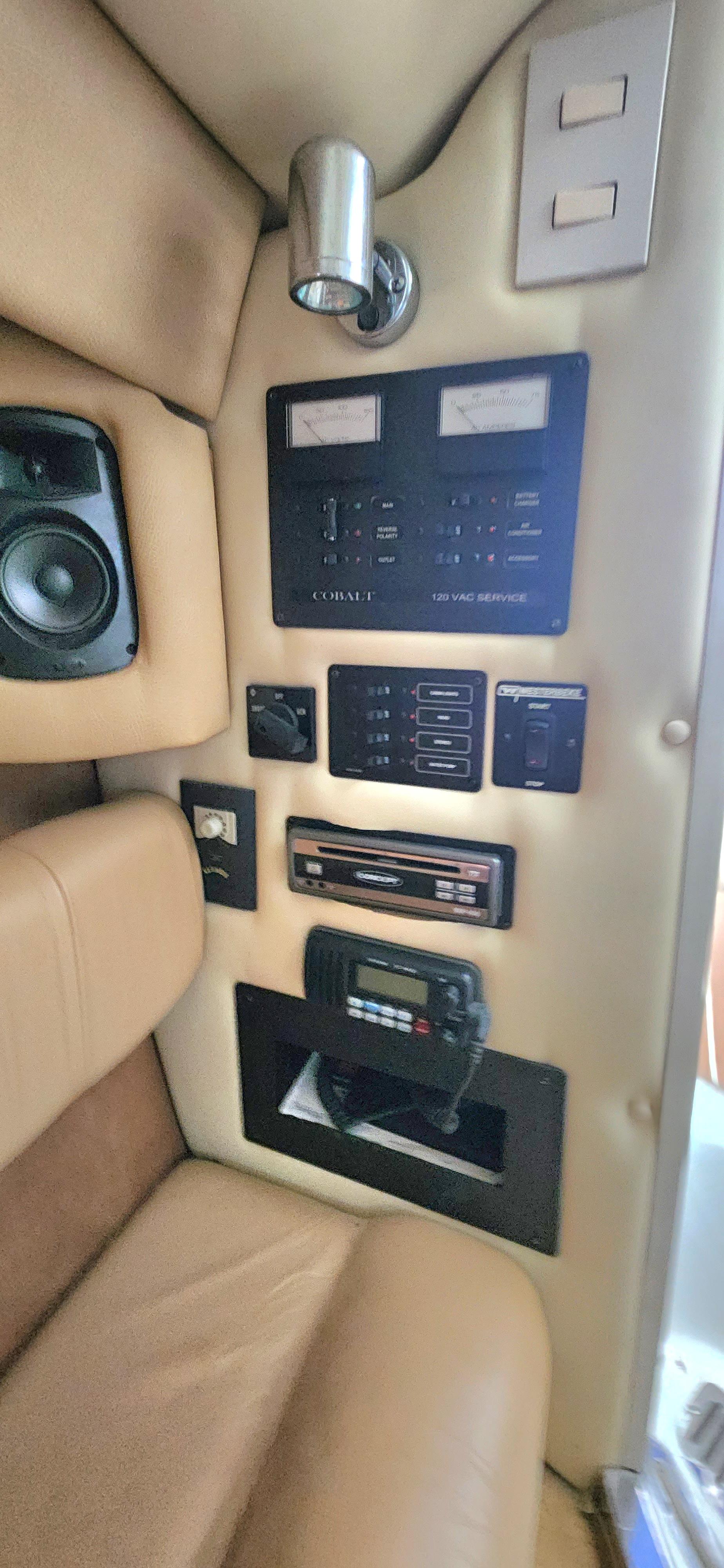 Control panel of a 2007 Cobalt 343 boat with beige interior and audio system.