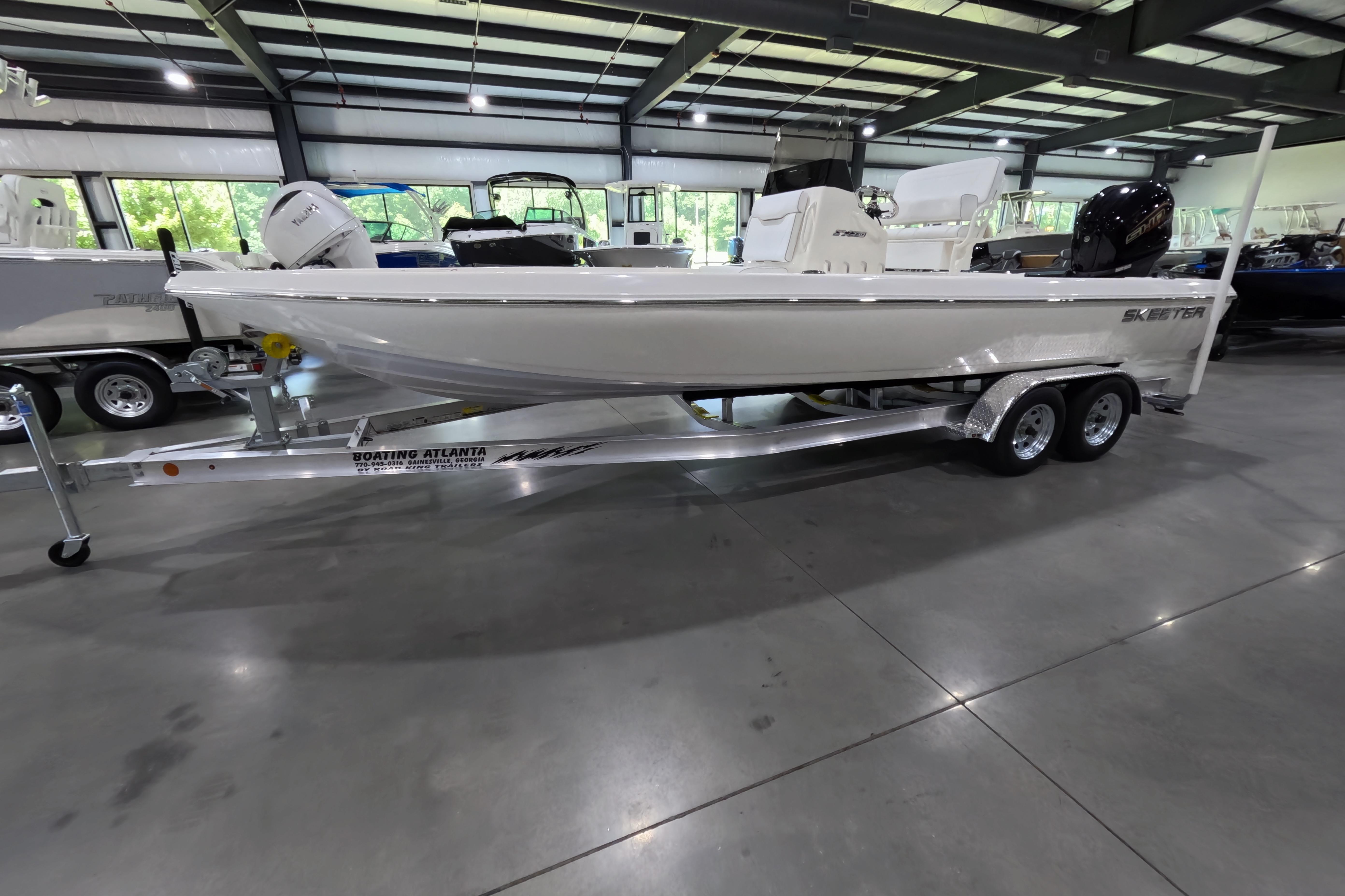 2026 Skeeter SX230 boat on trailer in indoor showroom setting.