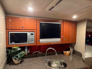 Galley area with microwave and sink in a yacht.