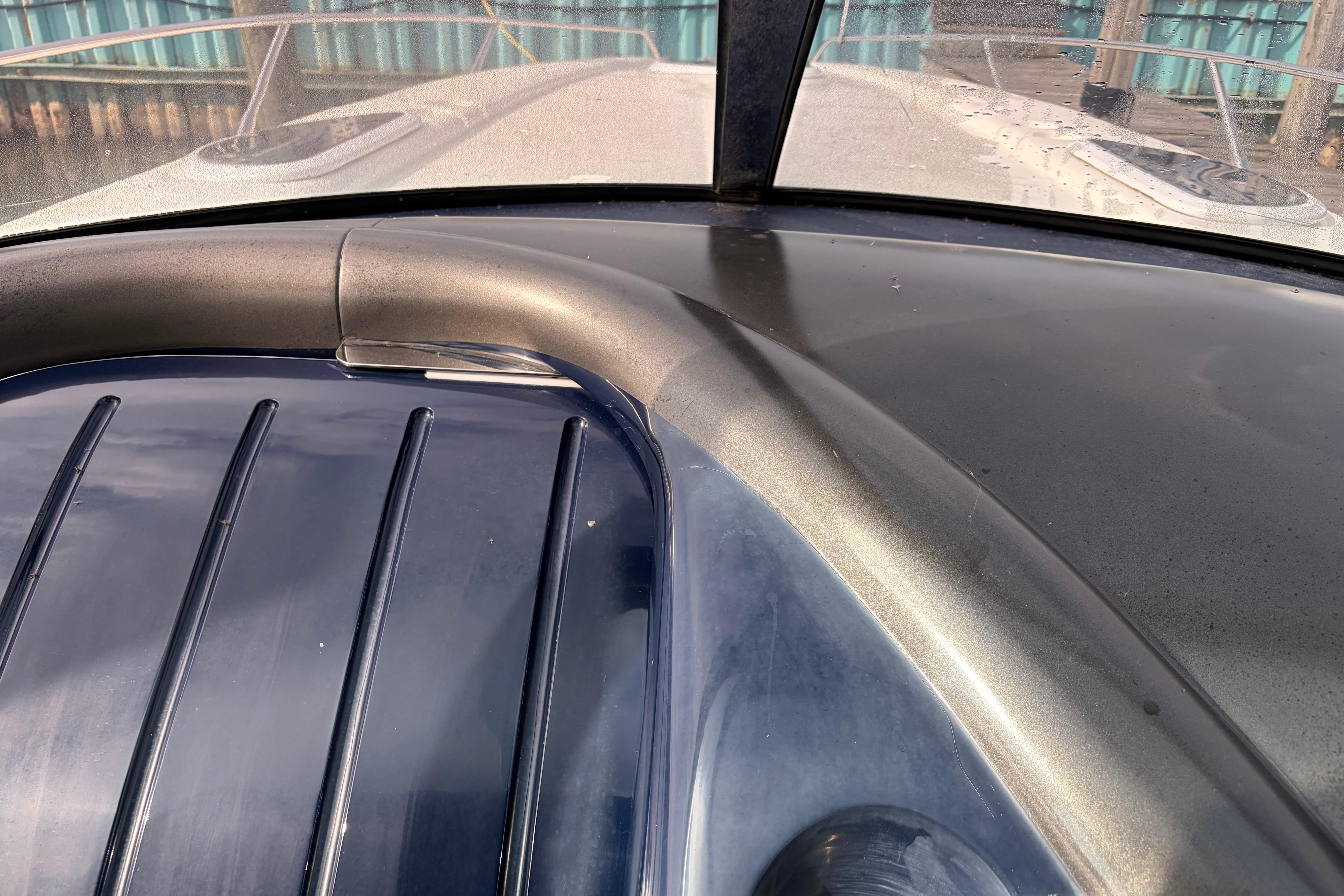 Close-up of 2000 Sunseeker Superhawk 34 yacht deck, showcasing sleek design and detailing.