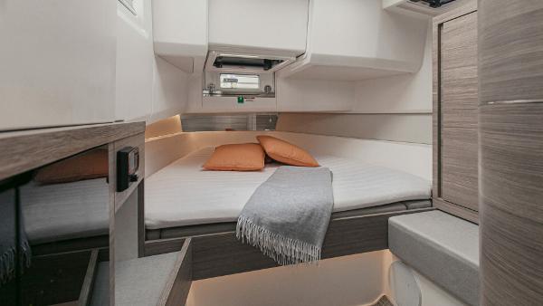 Interior cabin of 2025 Saxdor 400 GTC with bed, pillows, and blanket.