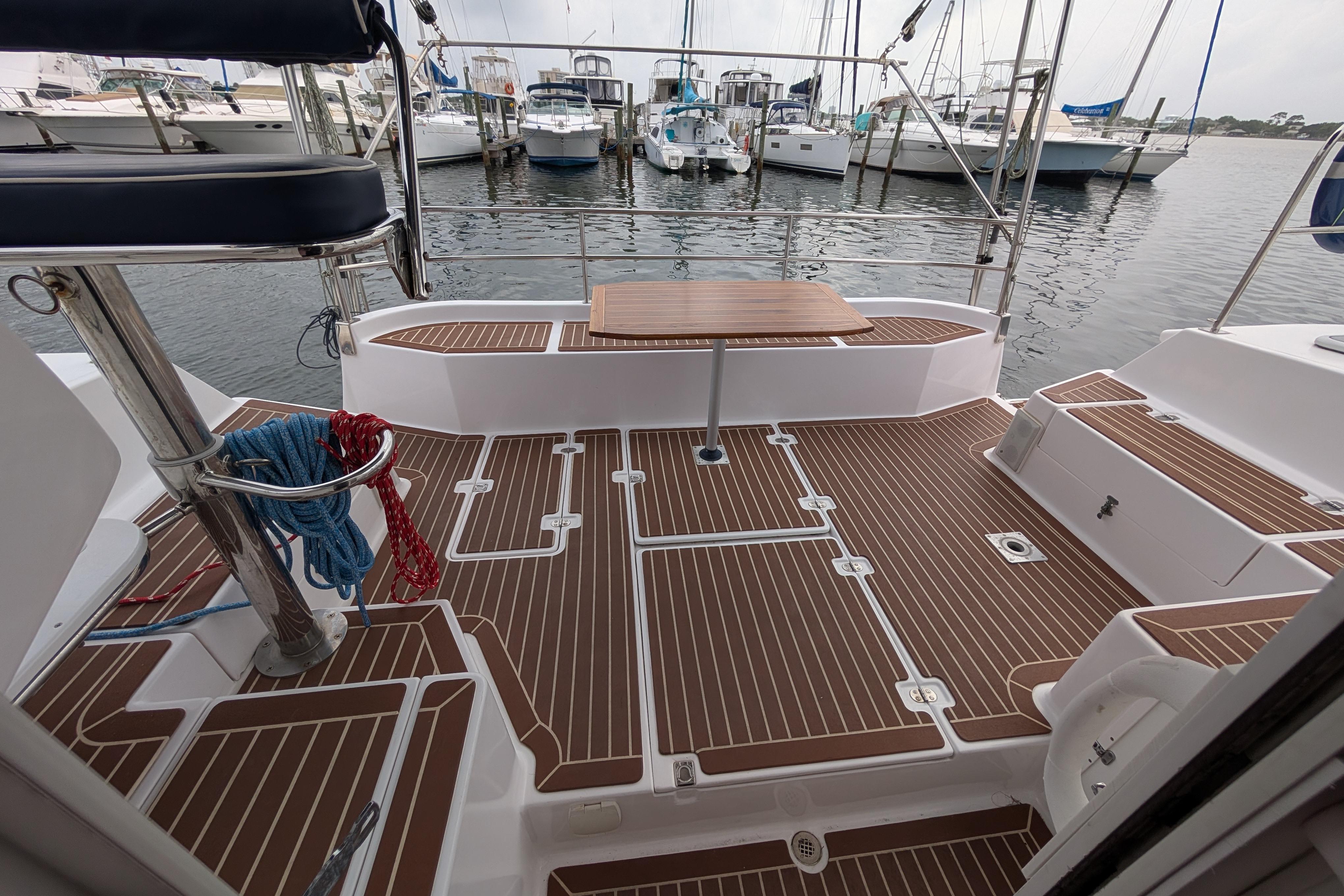 Spacious deck of 1999 Island Spirit 37 yacht, featuring elegant wood-patterned flooring.