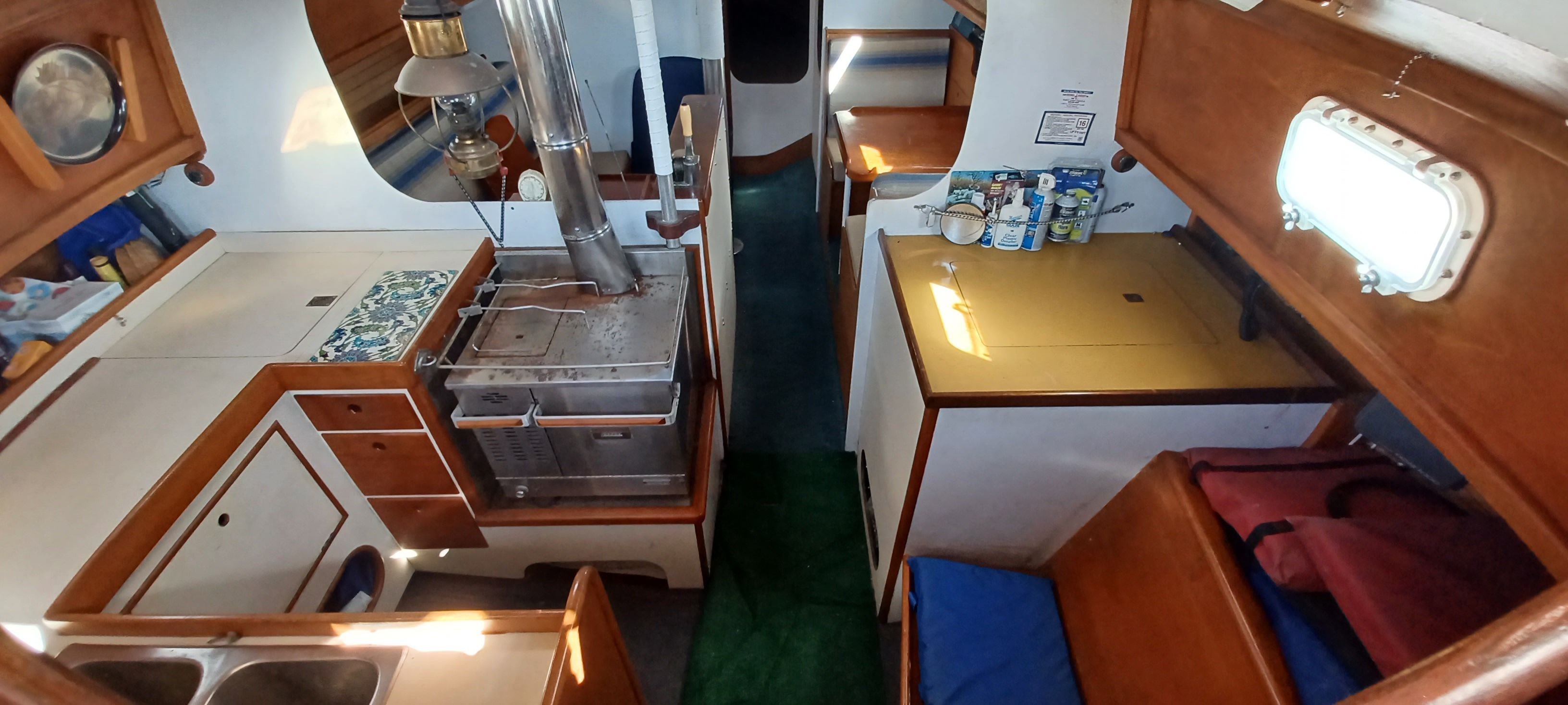 Interior of a sailboat with kitchen and sleeping area.