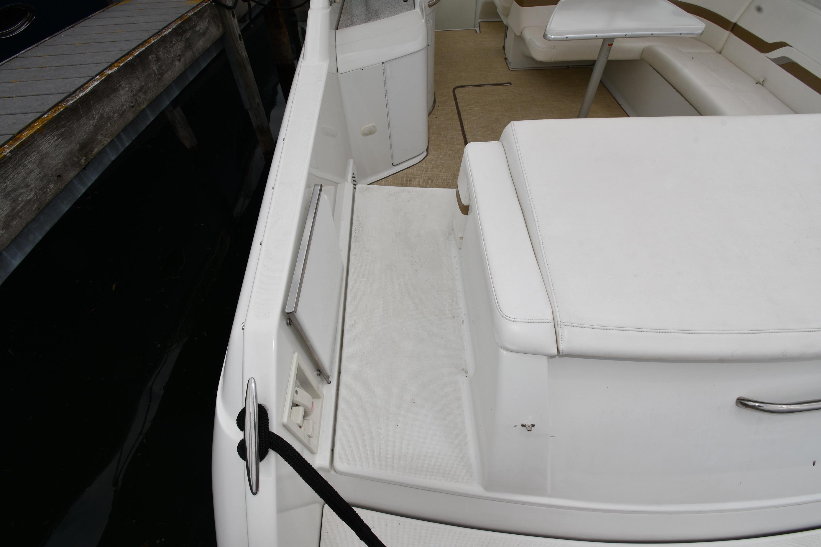 2004 Formula 330 Sun Sport boat interior with white seating and table.
