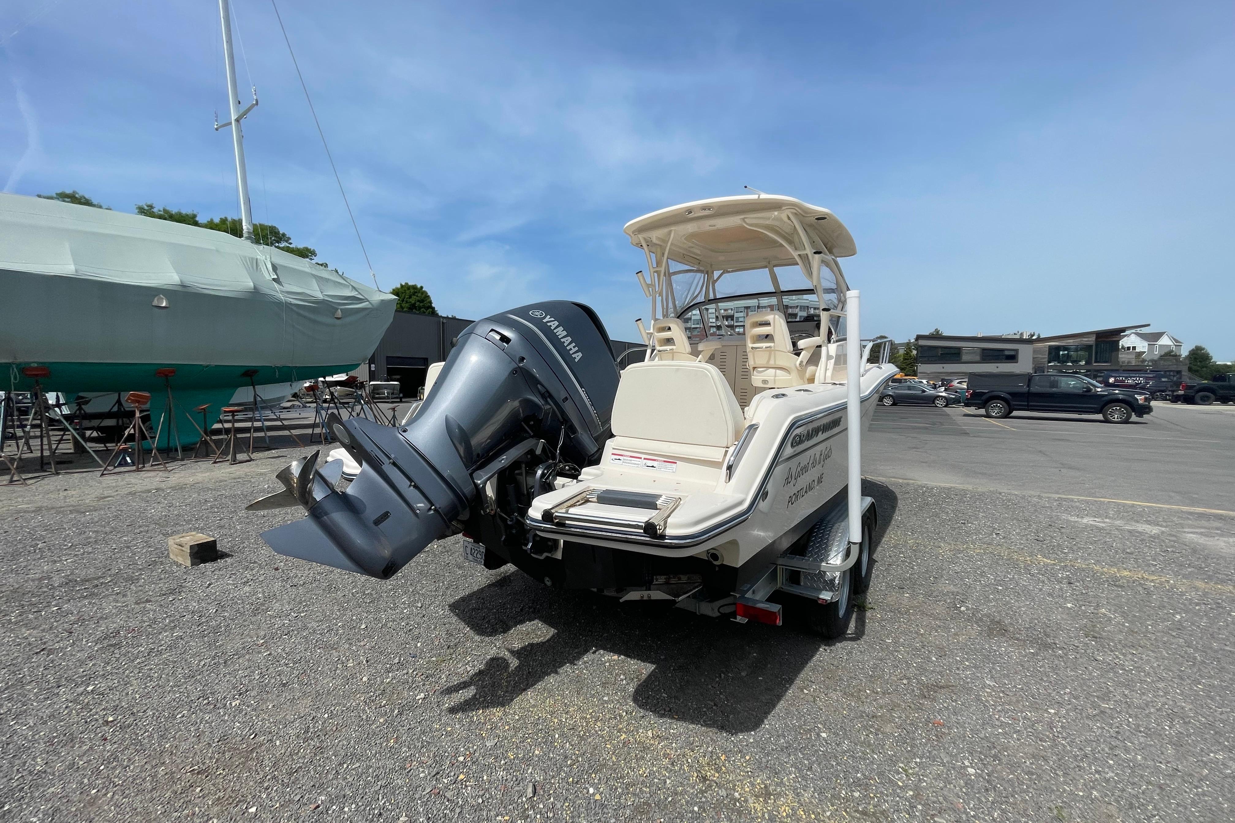 2024 Grady-White Adventure 218 boat with Yamaha outboard motor in a marina setting.