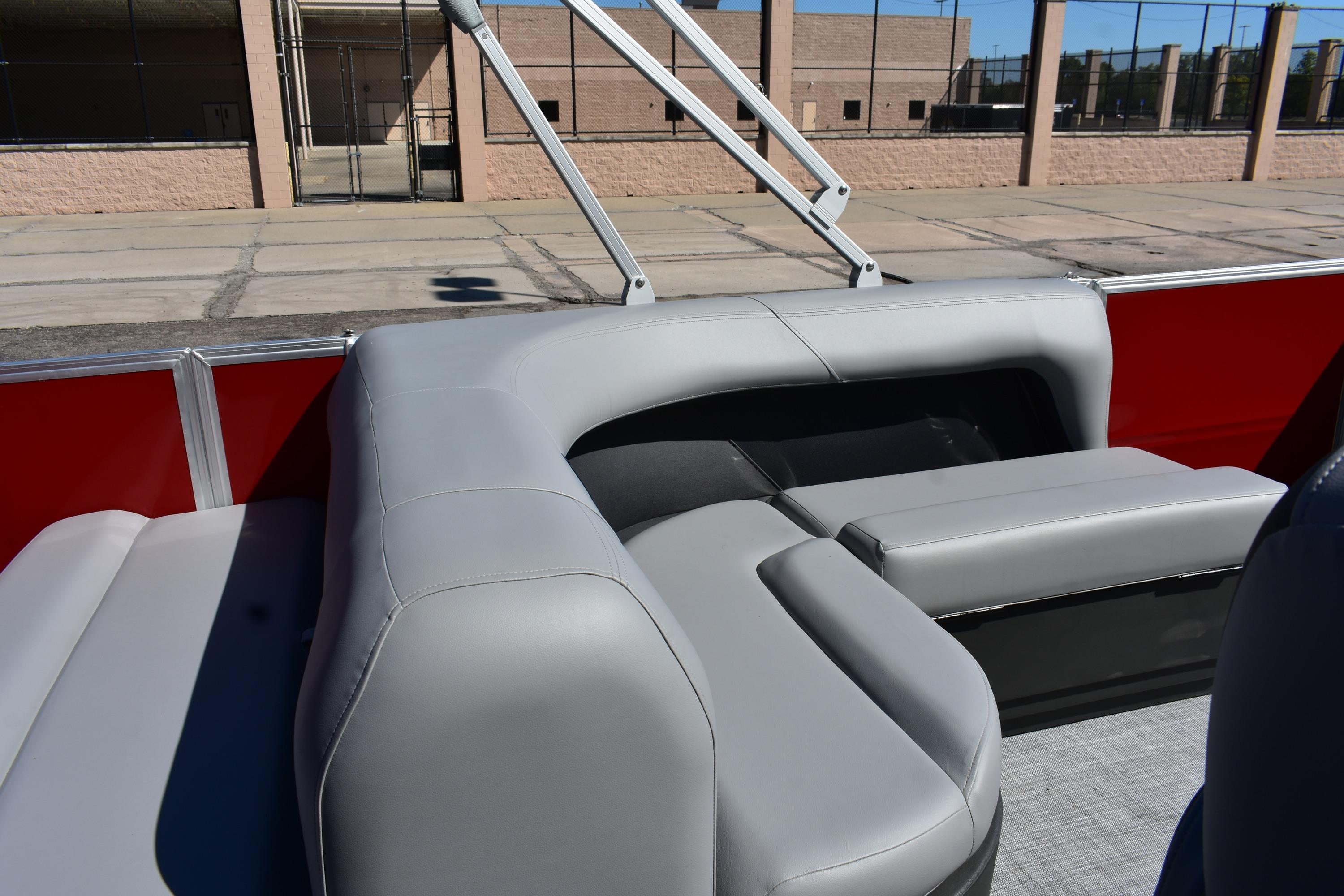 2026 Sun Tracker Party Barge 18 DLX with gray seating and red accents.