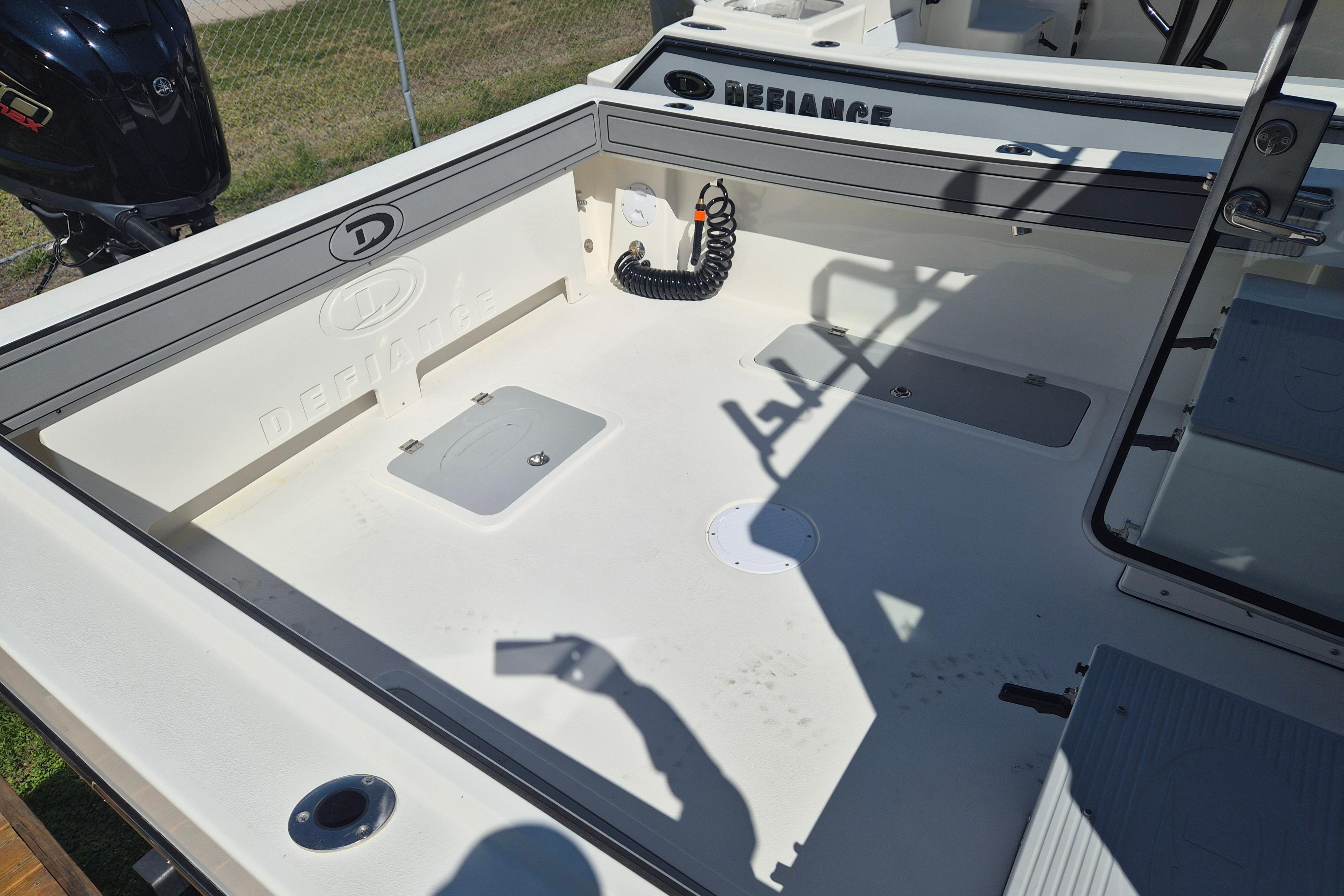 2026 Defiance Admiral 220 EX boat deck with storage compartments and clean design.