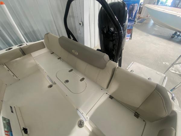 2024 Key West 219 FS boat interior with cushioned seating and storage compartments.
