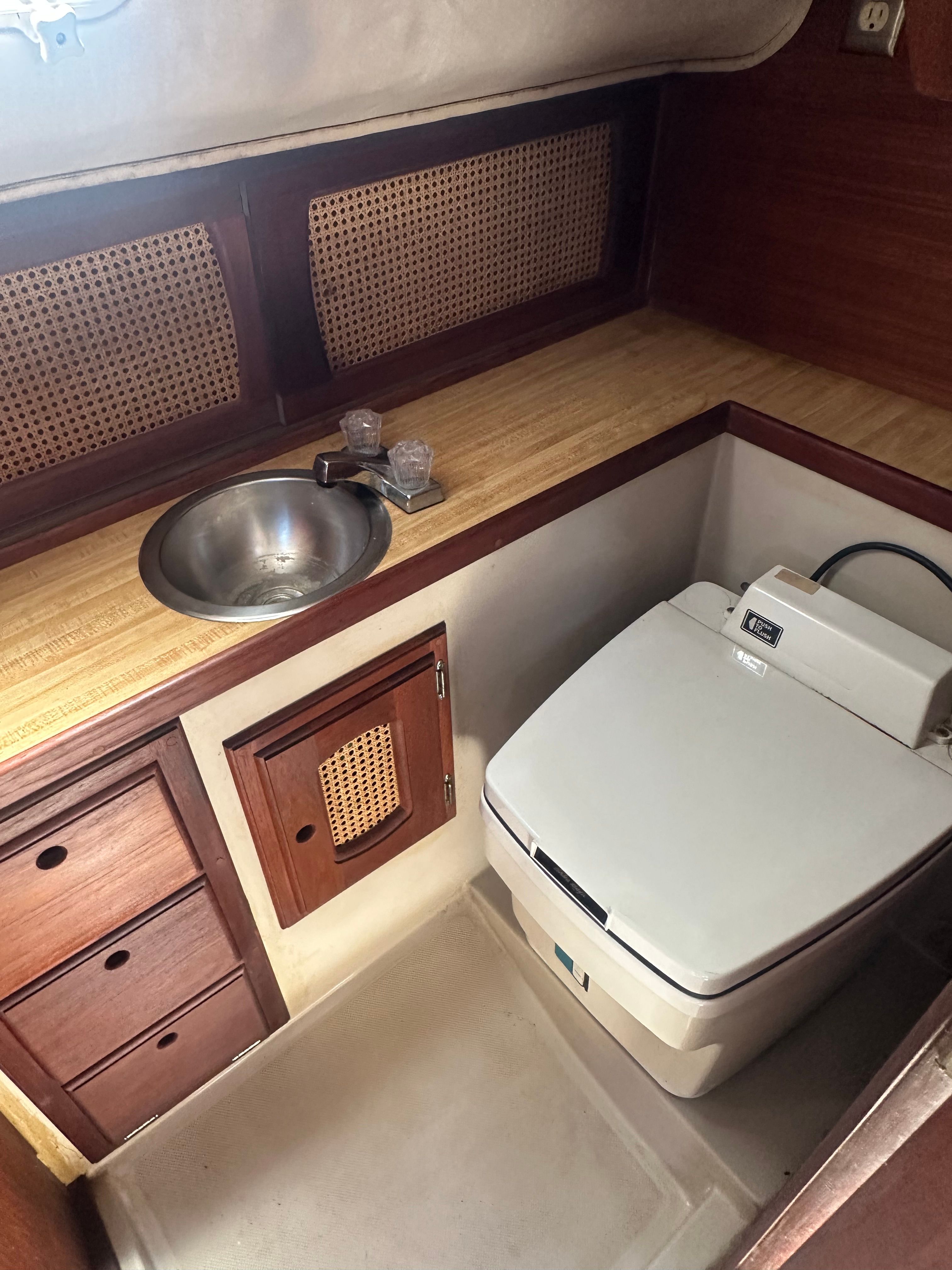 Interior of a yacht with a sink and toilet.