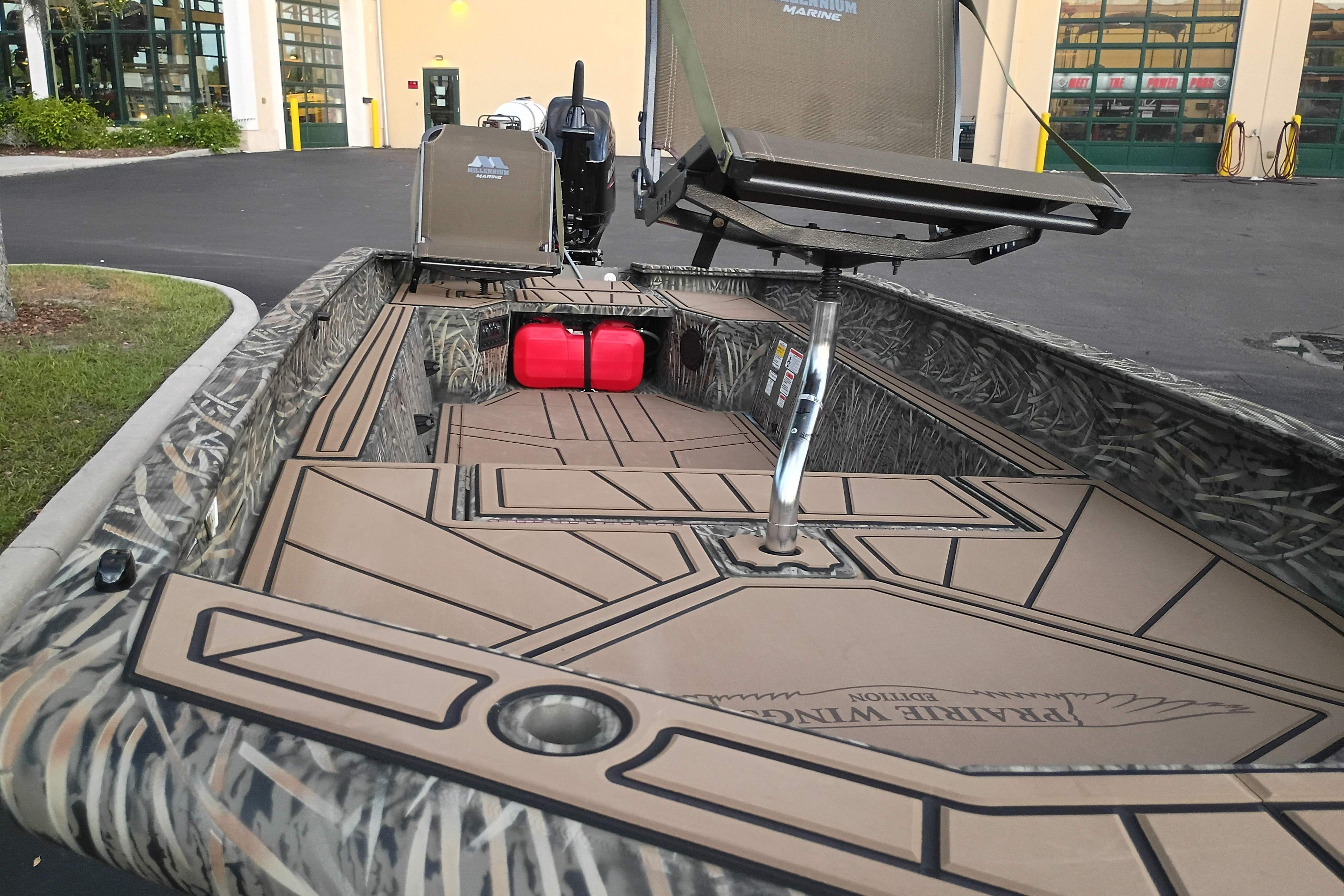 2026 Tracker Grizzly 1650 T Prairie Wings Edition boat with camo design and seating.