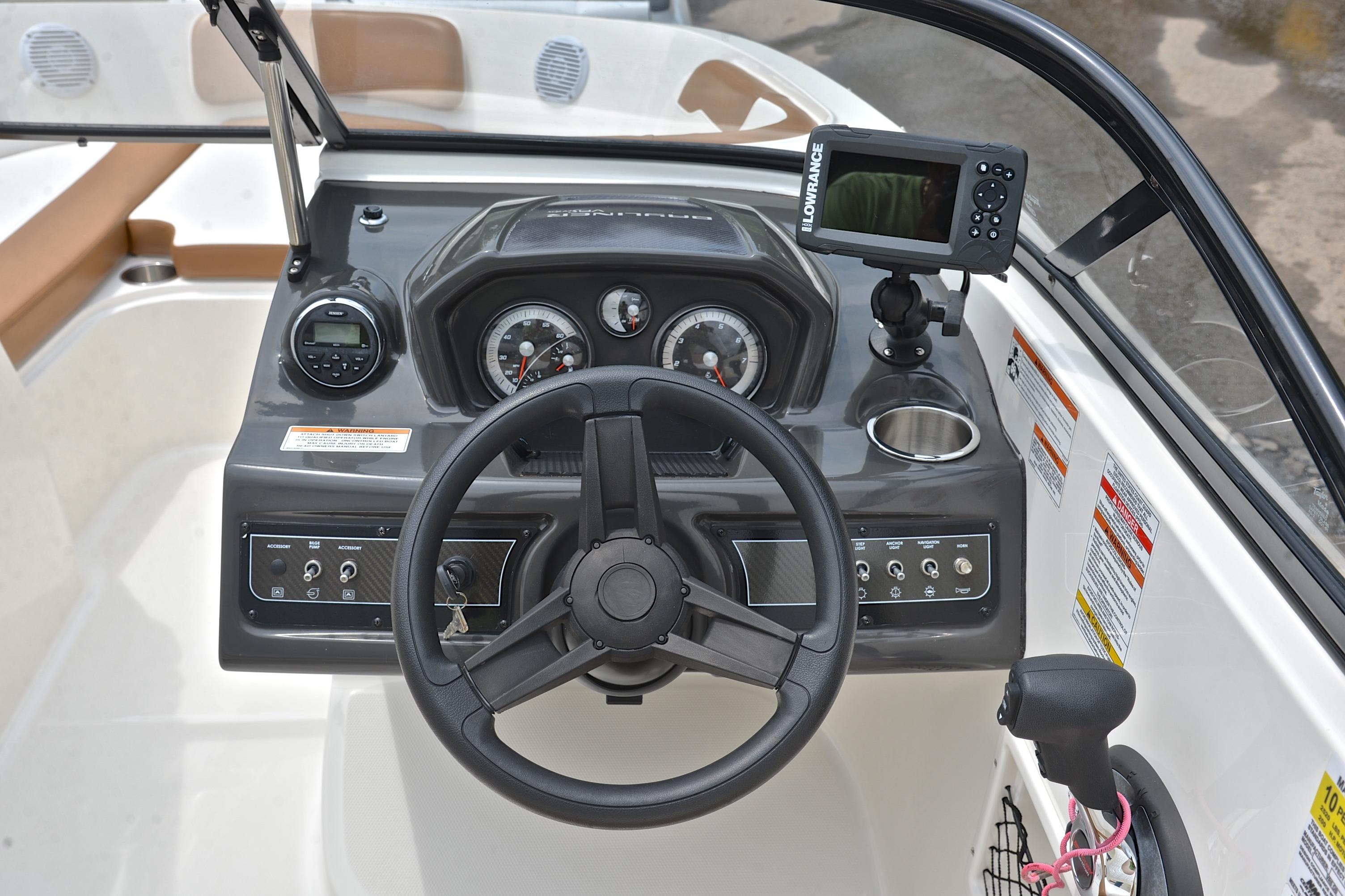 2019 Bayliner VR6 Bowrider OB dashboard with steering wheel and navigation system.