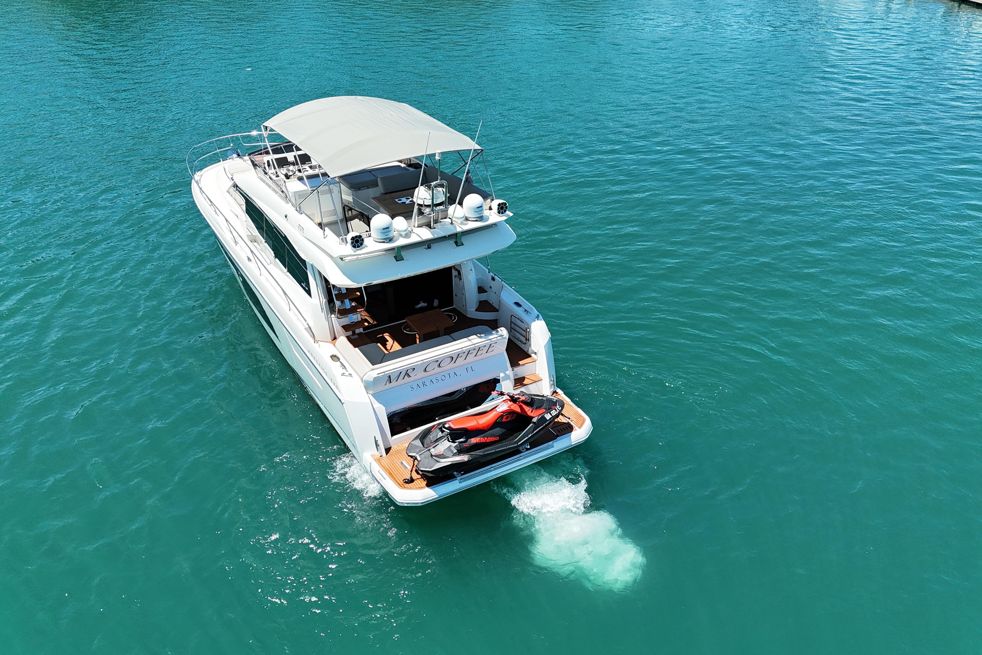 Luxury 2022 Prestige 520 yacht cruising on clear blue waters.
