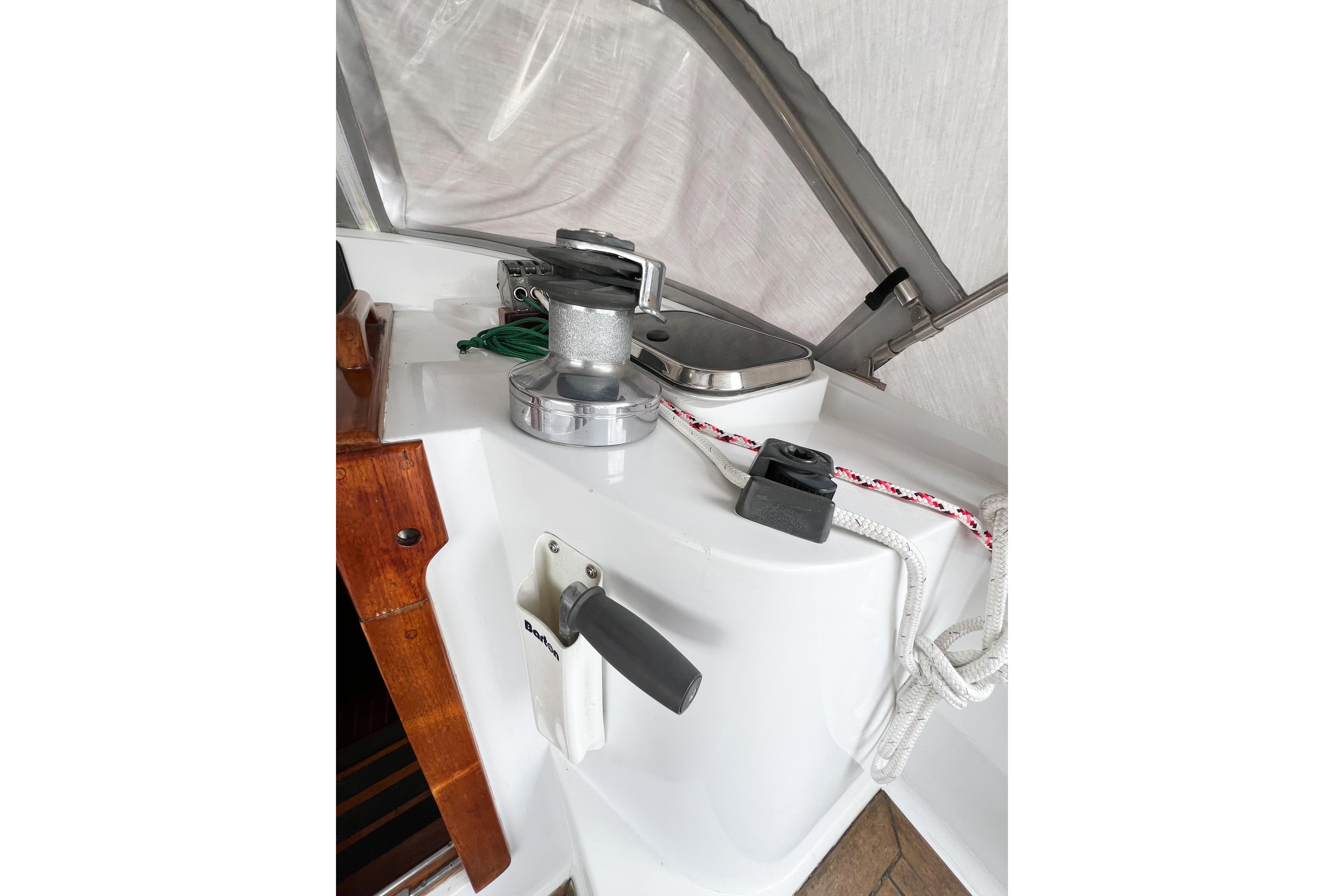 Deck equipment on a 1984 Trintella 42 sailboat, featuring winch and ropes.