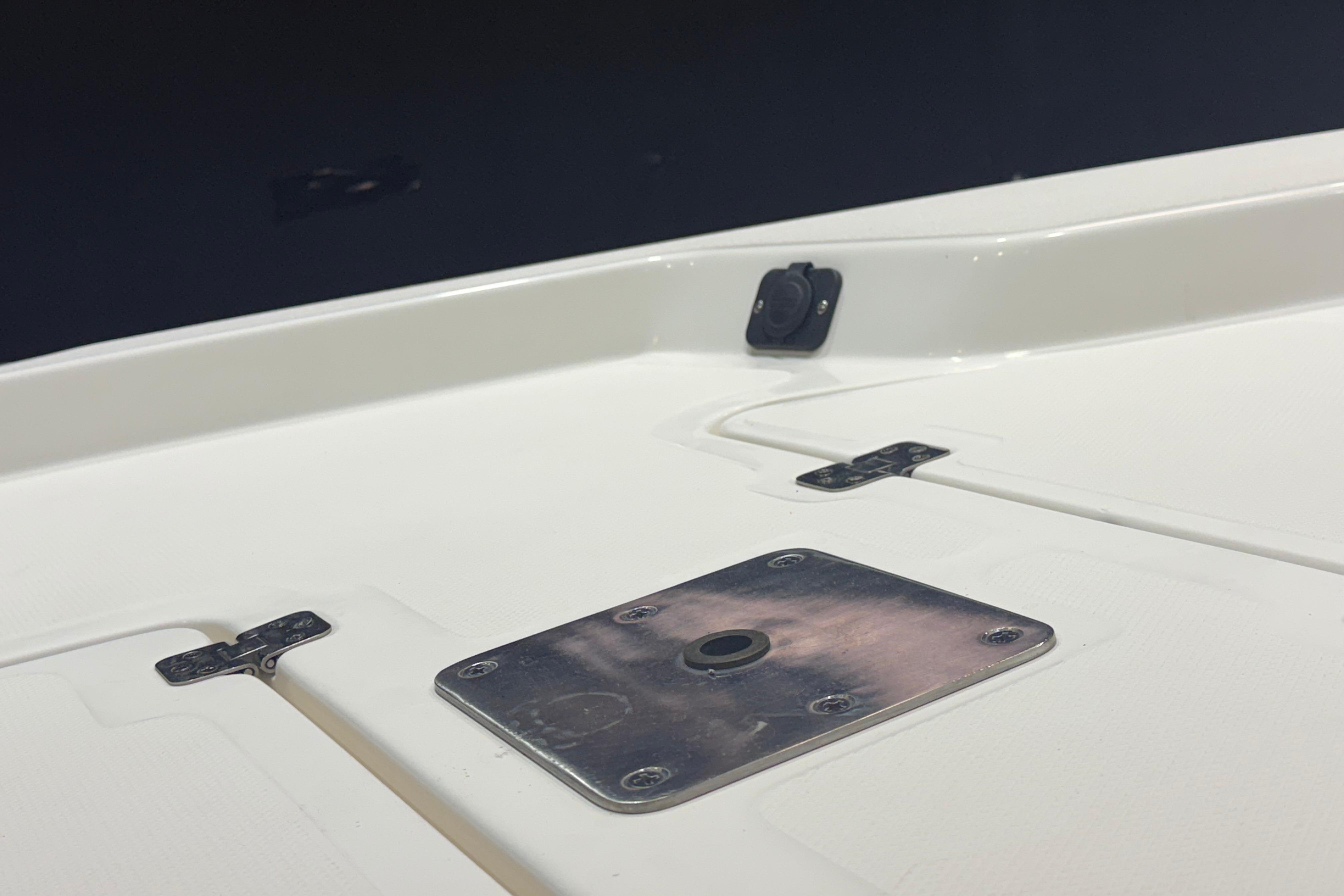 2023 NauticStar 215 XTS boat deck with metal fittings and clean white surface.
