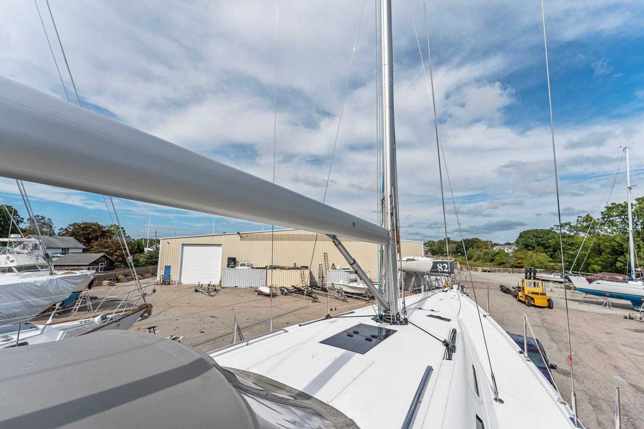 Italia Yachts 13.98 sailboat, 2015 model, docked in a shipyard under a partly cloudy sky.