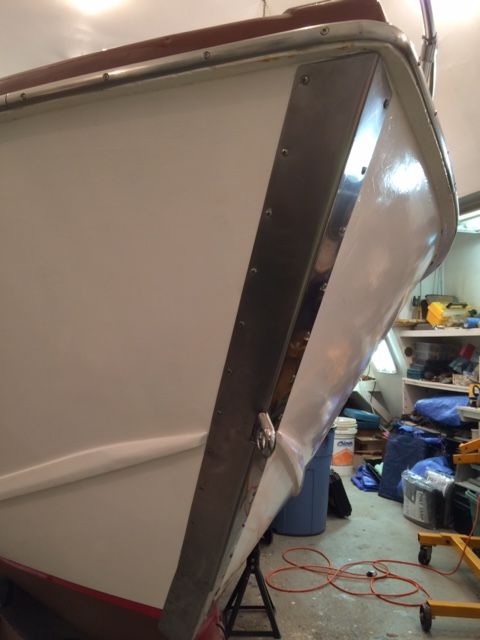 Close-up of the bow of a 1959 Owens Flagship boat in a workshop.