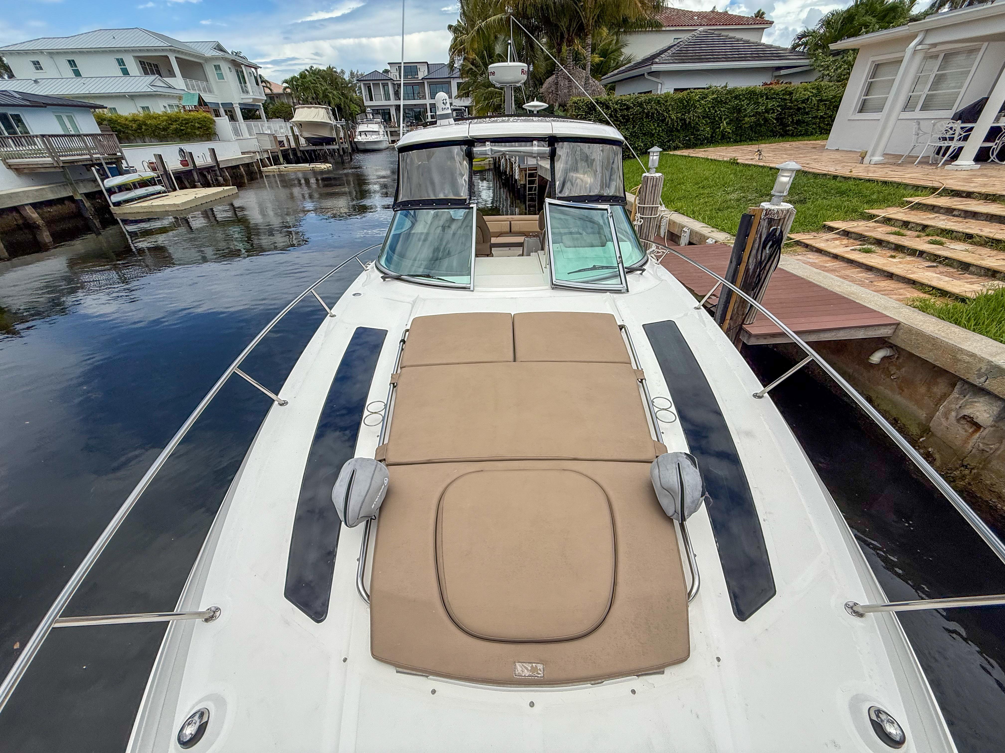 2016 Sea Ray 350 Sundancer yacht docked in a residential canal setting.