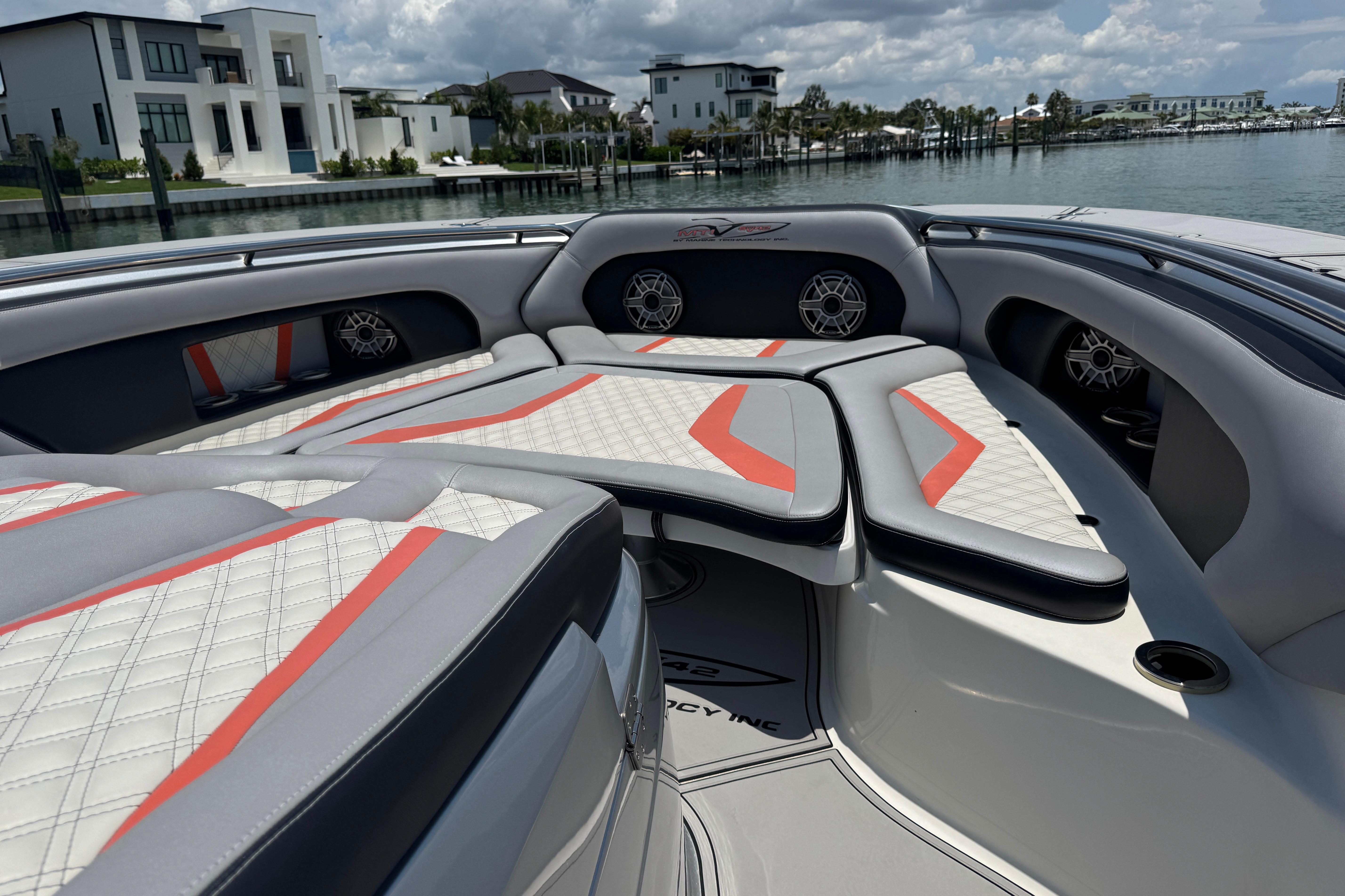 Luxurious 2017 MTI V42 boat interior with stylish seating and waterfront view.