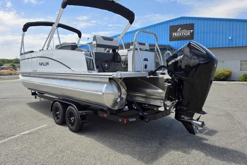 2026 Avalon Catalina Quad Lounge Shift pontoon boat with Mercury engine on trailer.