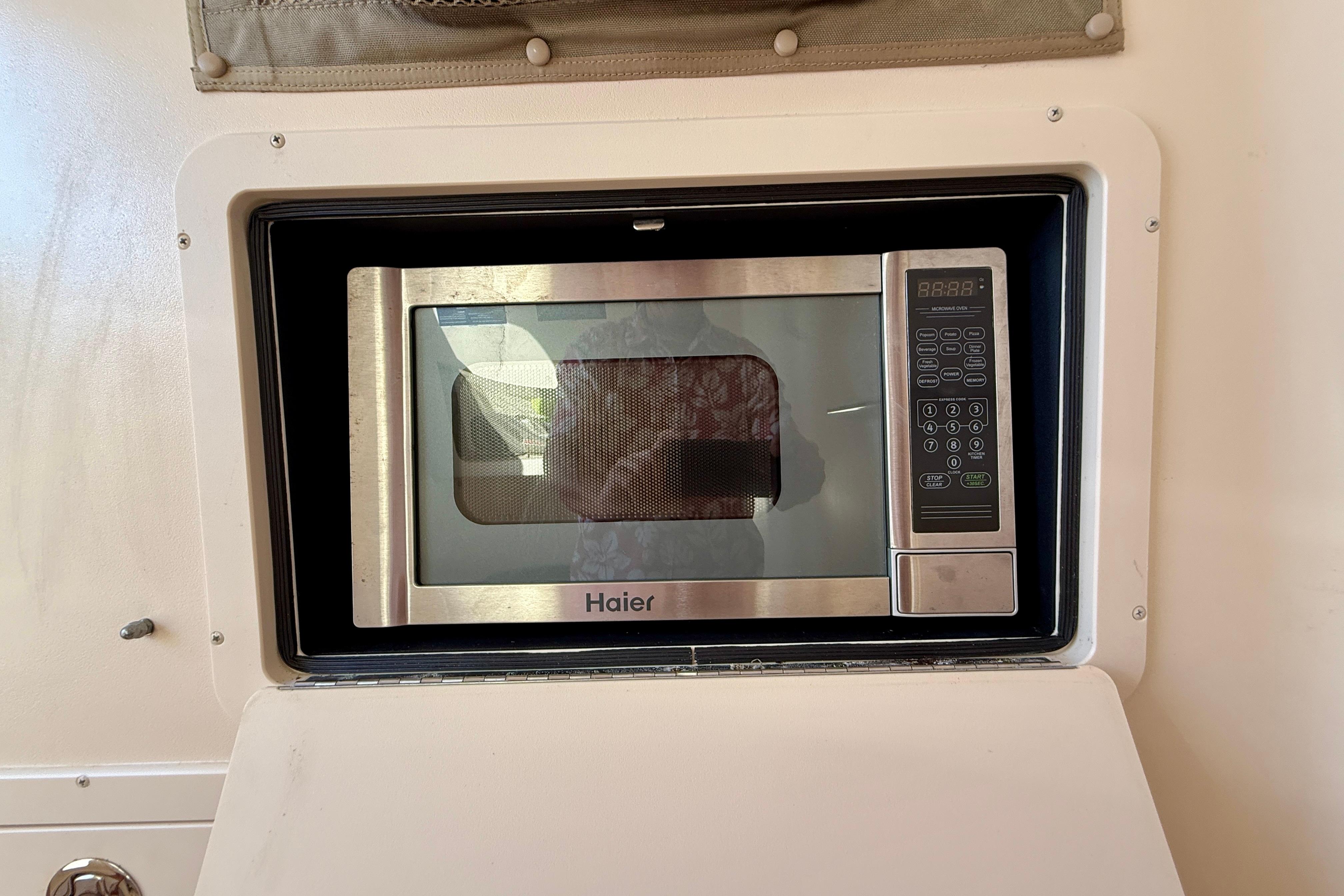 Built-in Haier microwave inside a 2012 Grady-White Canyon 336 boat.