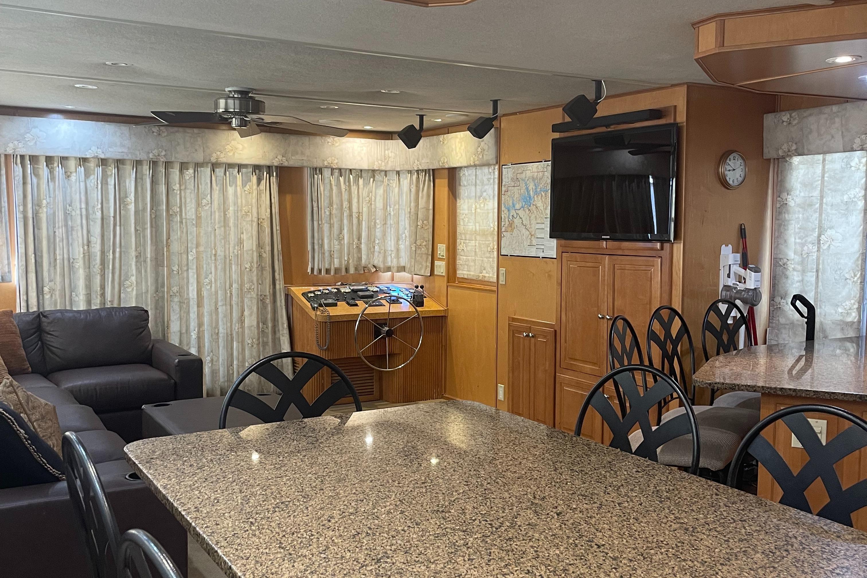 Interior of 2003 Sharpe Wailea Trip houseboat with granite countertops and cozy seating area.