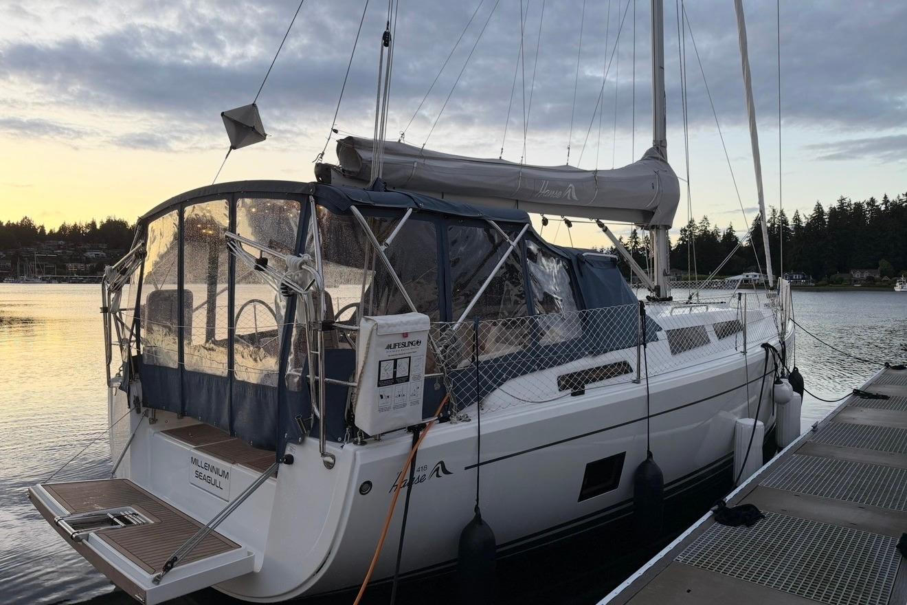 Sailing yacht Hanse 418, 2022 model, docked at sunset with protective canopy.